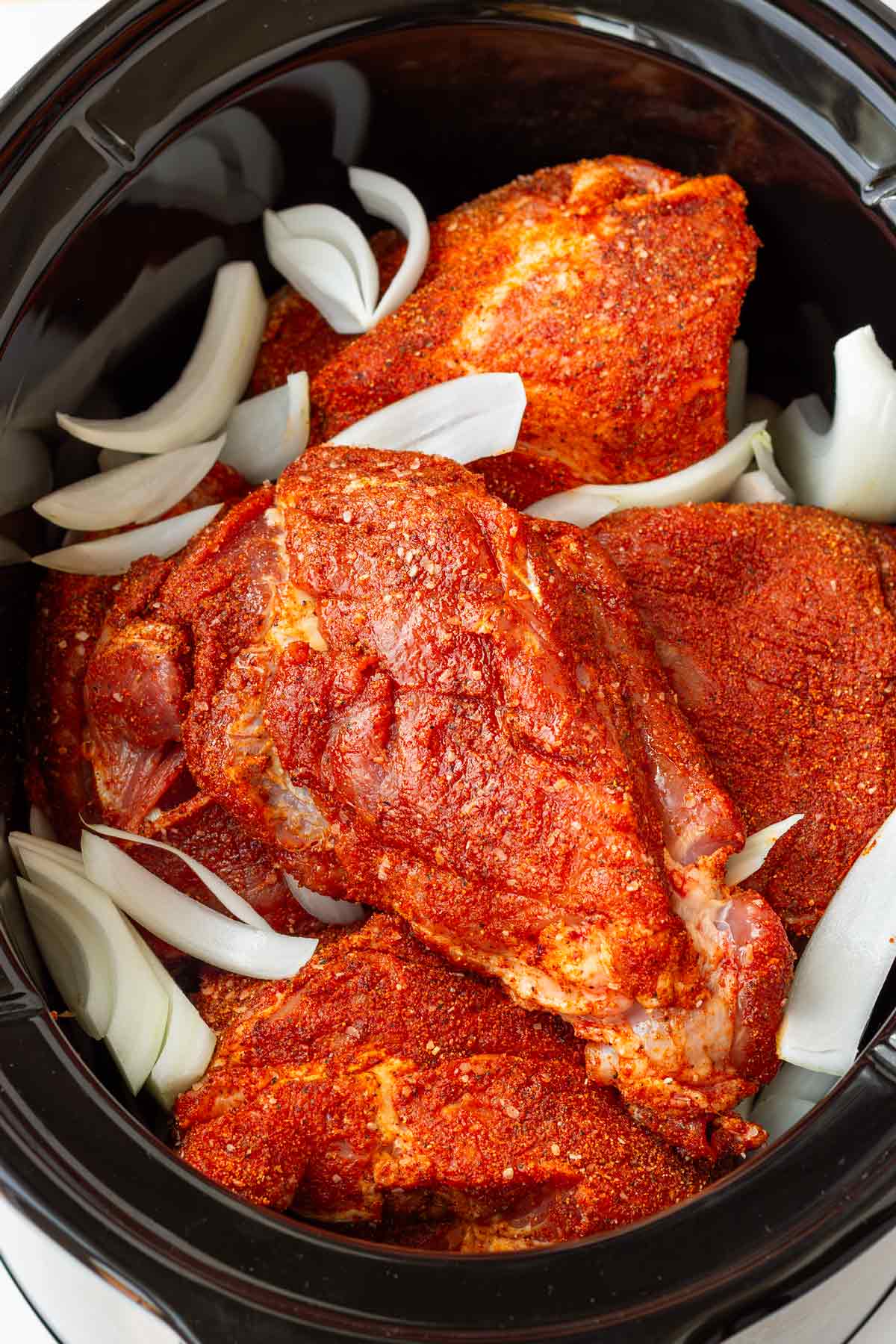 onions, garlic, and pork added in the slow cooker