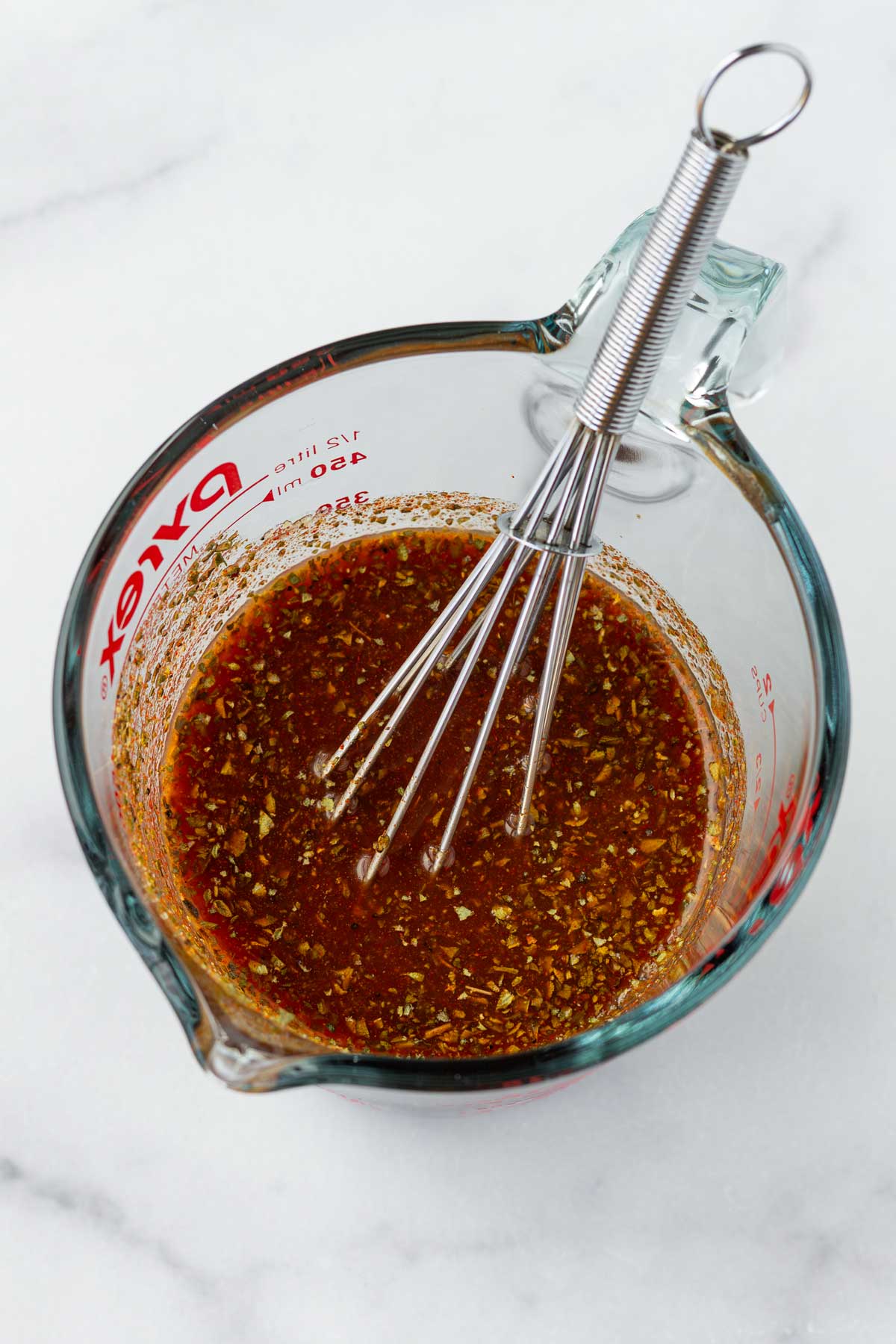 mixed sauce for the chicken in a glass measuring cup