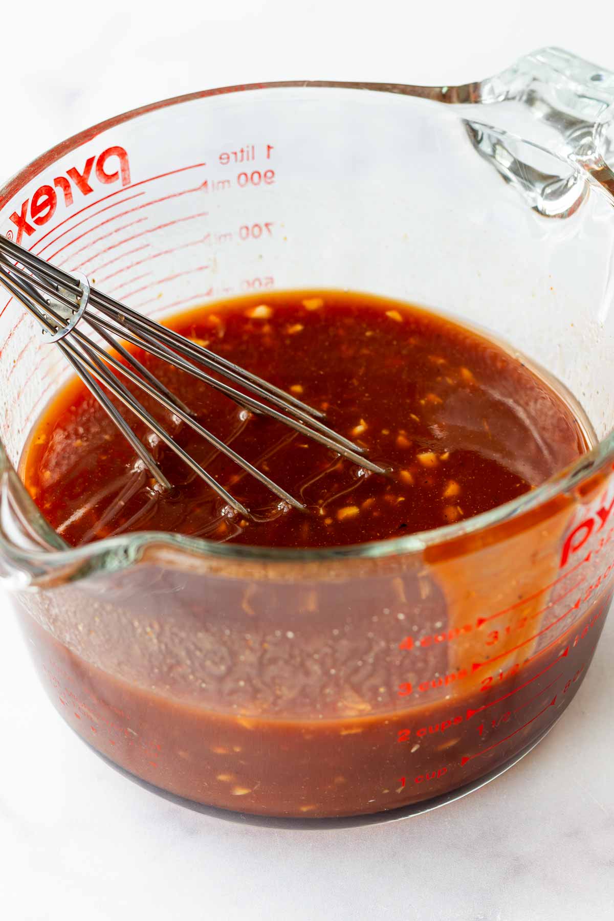 the cooking liquid mixed in a large measuring cup