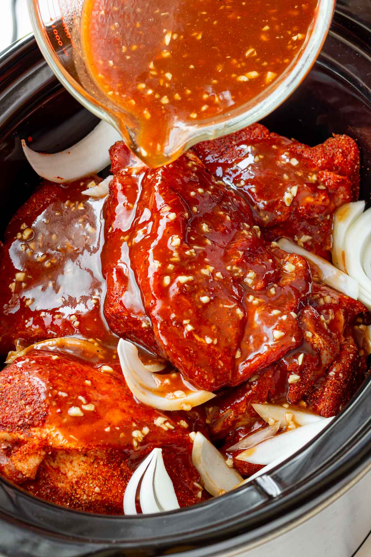 adding the cooking liquid into the crockpot