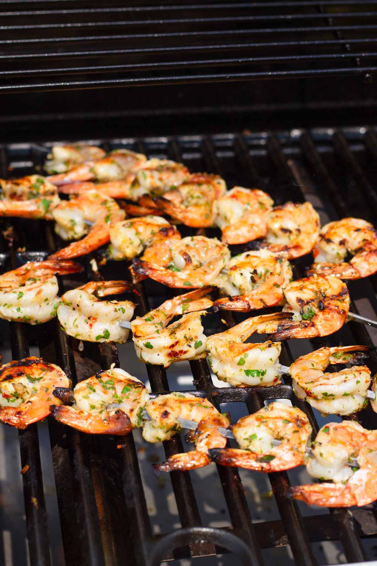 cooked grilled shrimp skewers on the grill