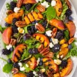 grilled peach platter with berries and candied pecans
