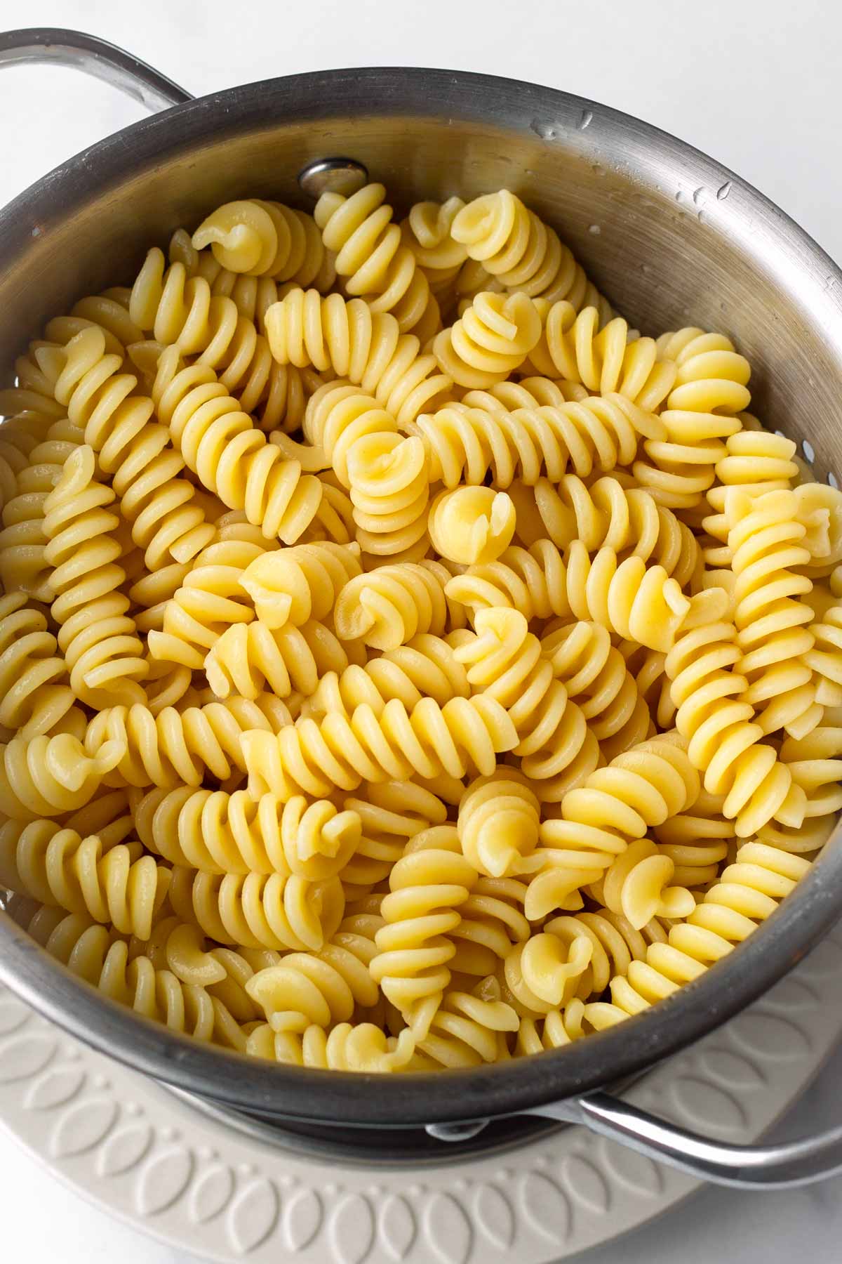 cooked rotini pasta drained in a colander