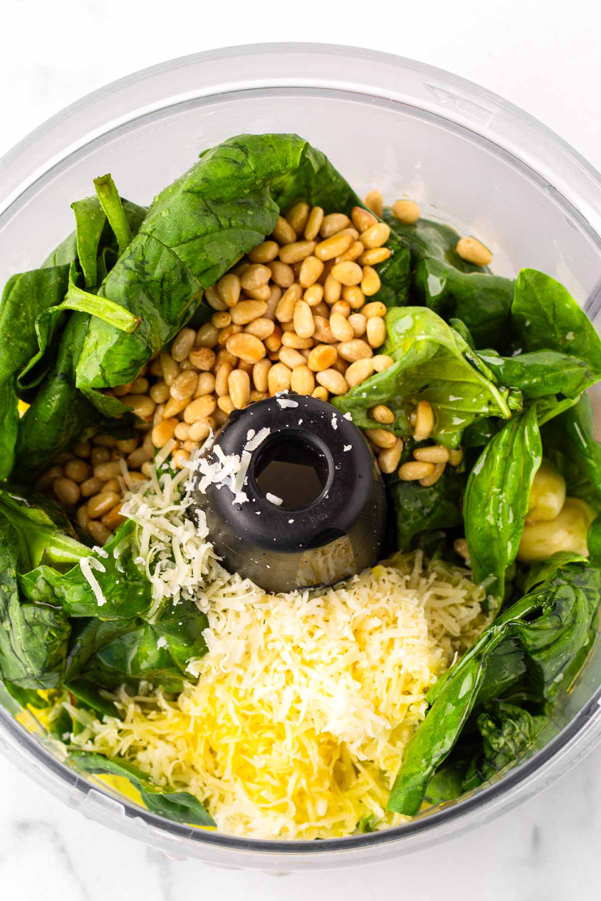 all pesto ingredients in food processor bowl