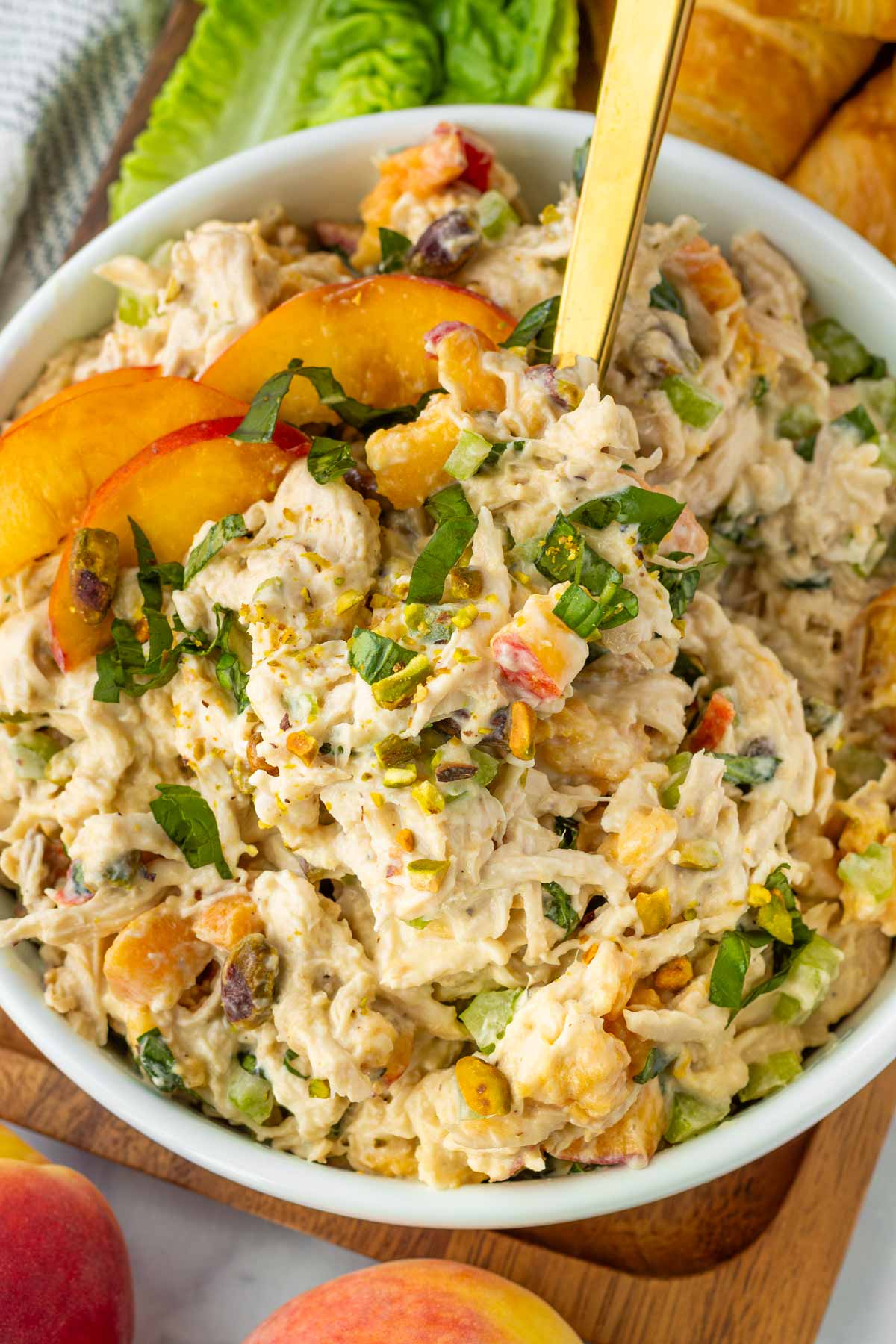 serving peach basil chicken salad with a spoon
