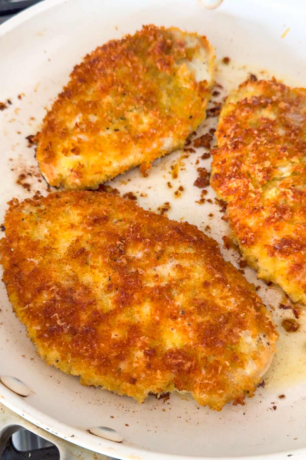 cooked crispy chicken cutlets in pan