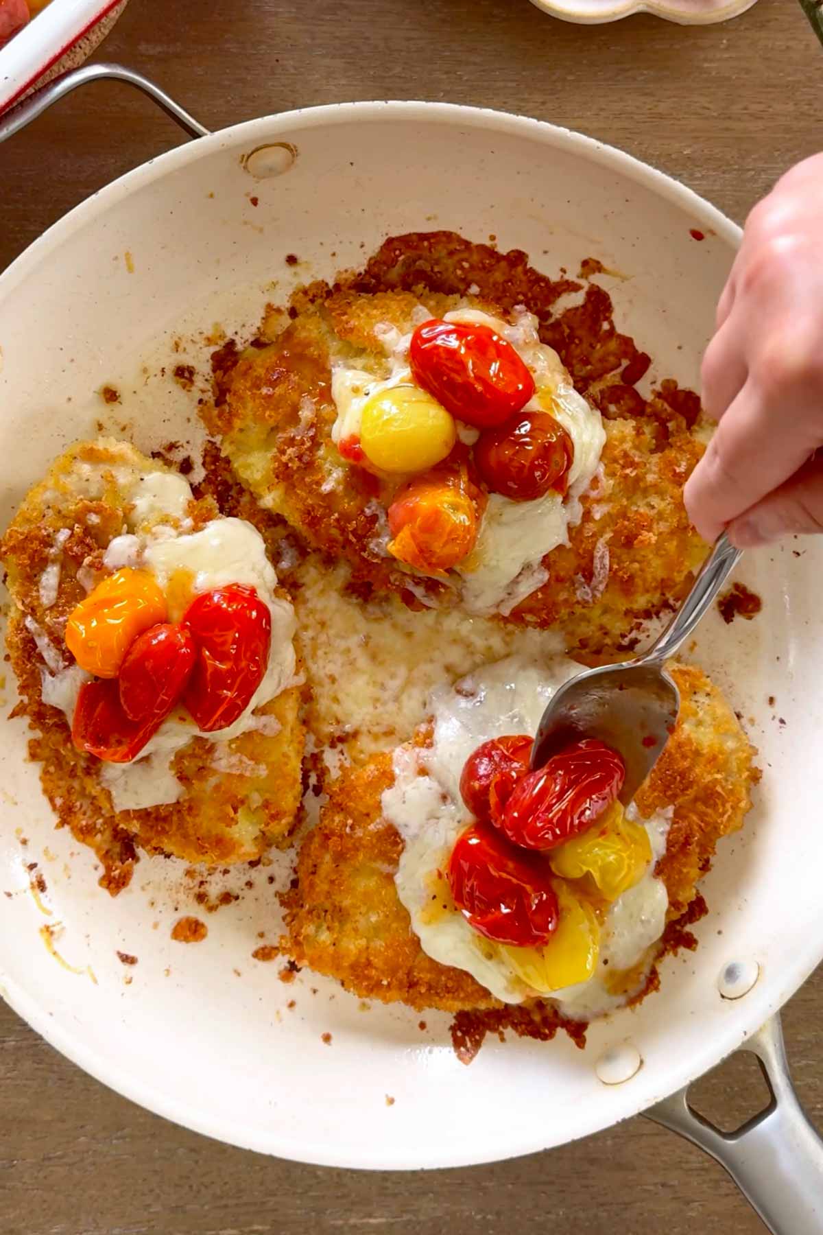 topping chicken parmesan with jammy roasted tomatoes