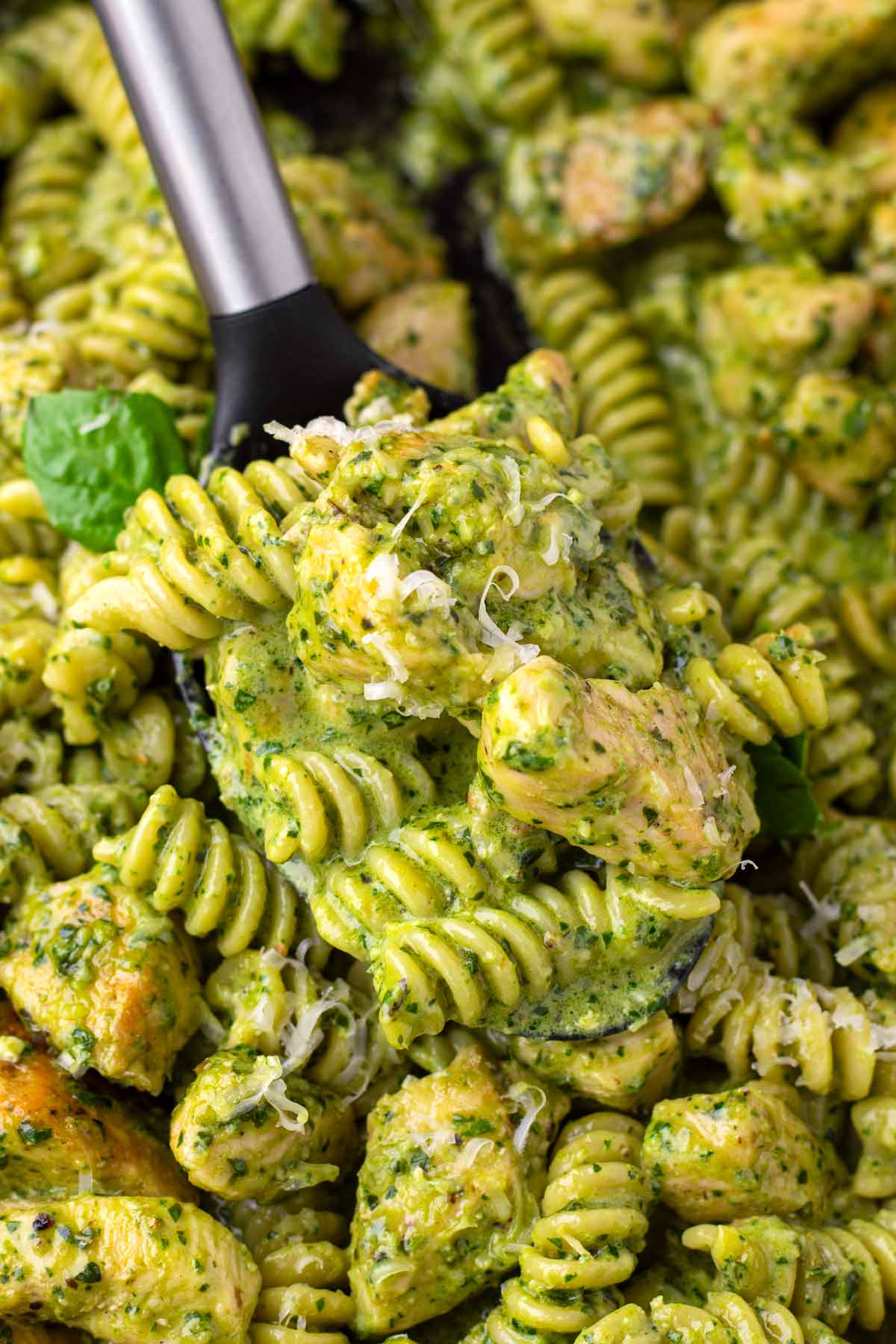 serving chicken pesto pasta from pan