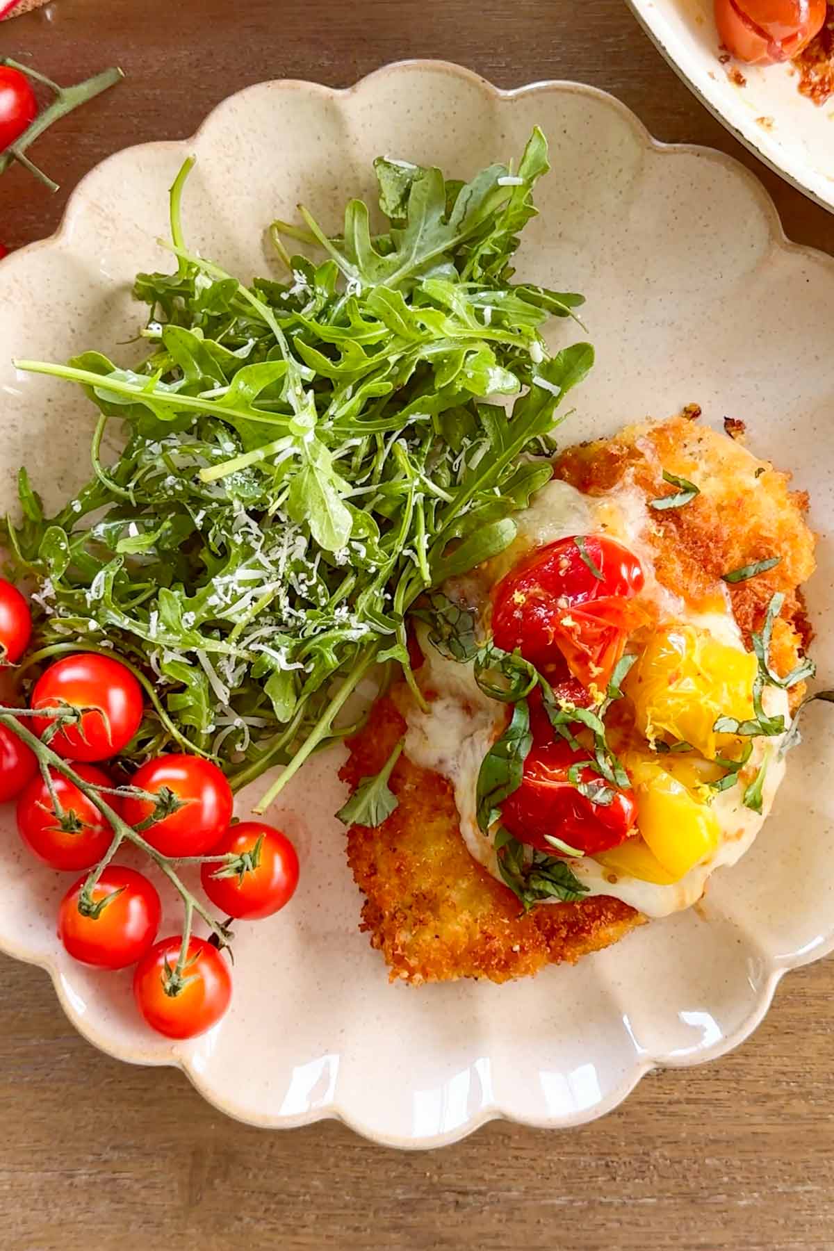 platter with summer chicken parmesan, arugula, and vine tomatoes