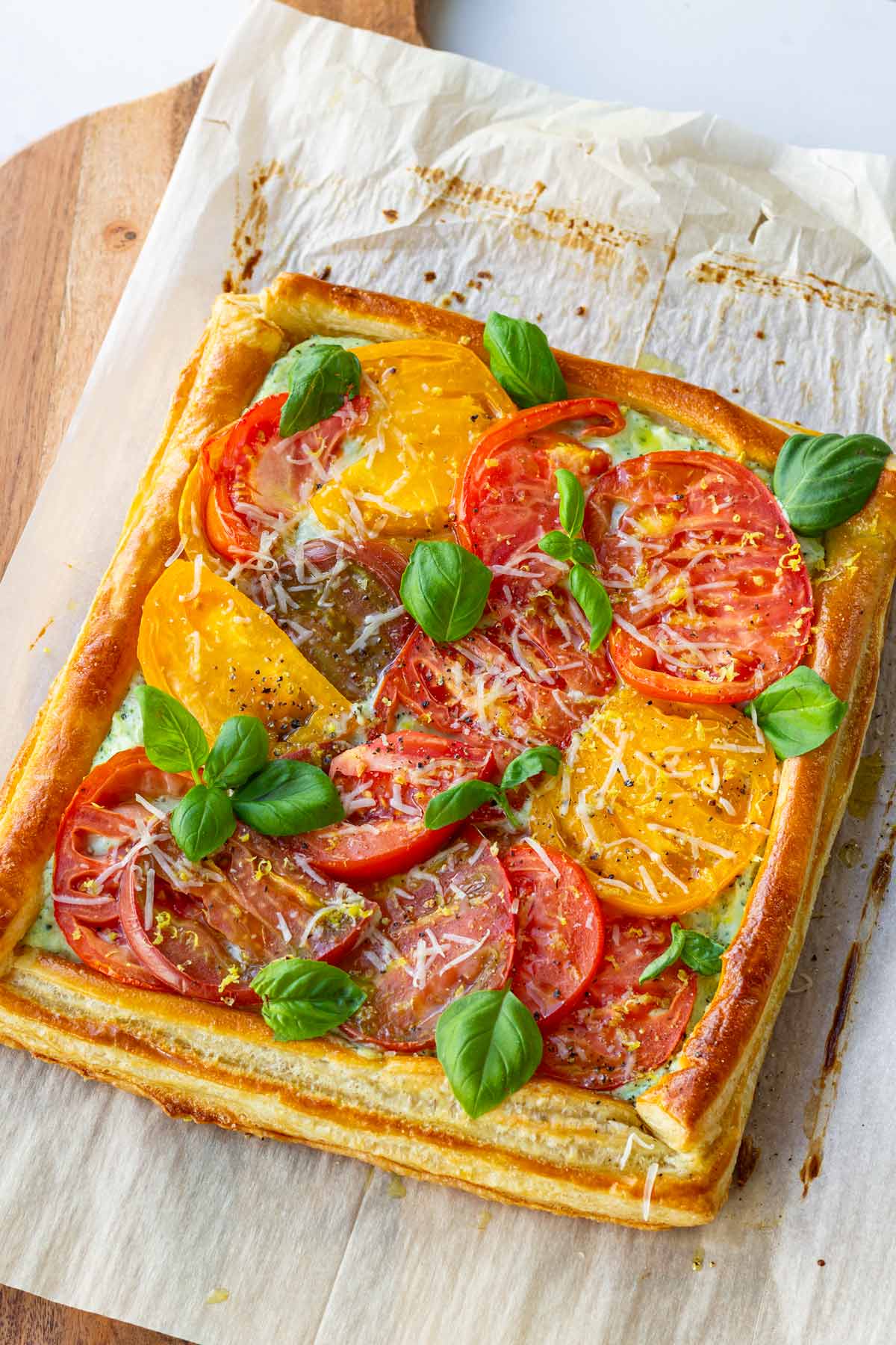 tomato tart with puff pastry on parchment paper