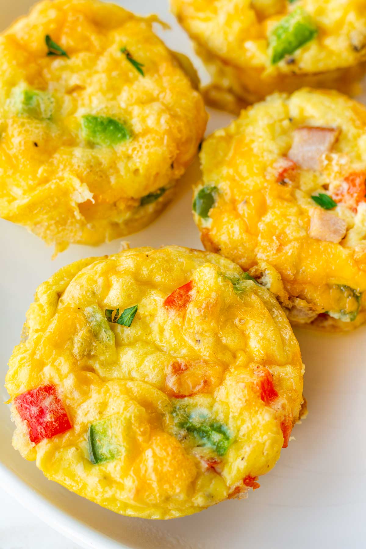 close up of baked egg bites with peppers and ham