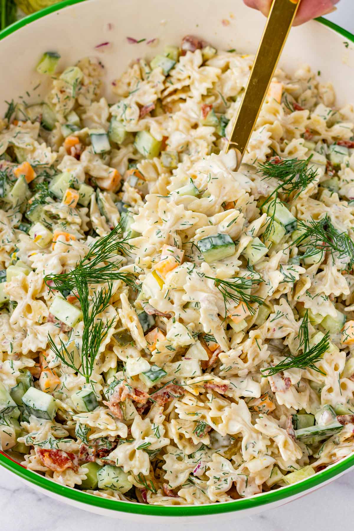 spoonful of dill pickle pasta salad in large bowl