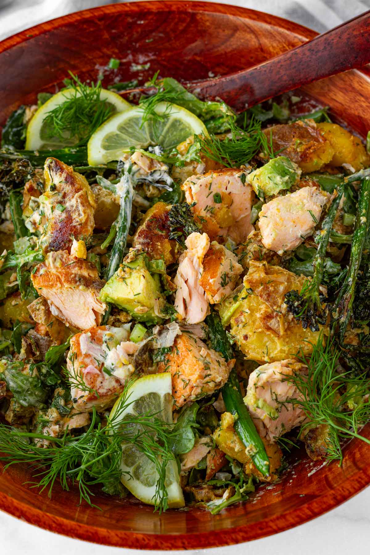 mixing salmon potato salad