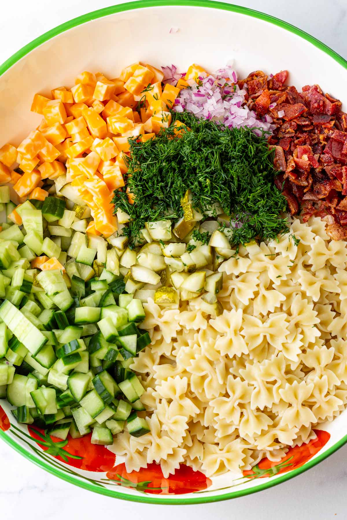 ingredients for dill pickle pasta salad in bowl