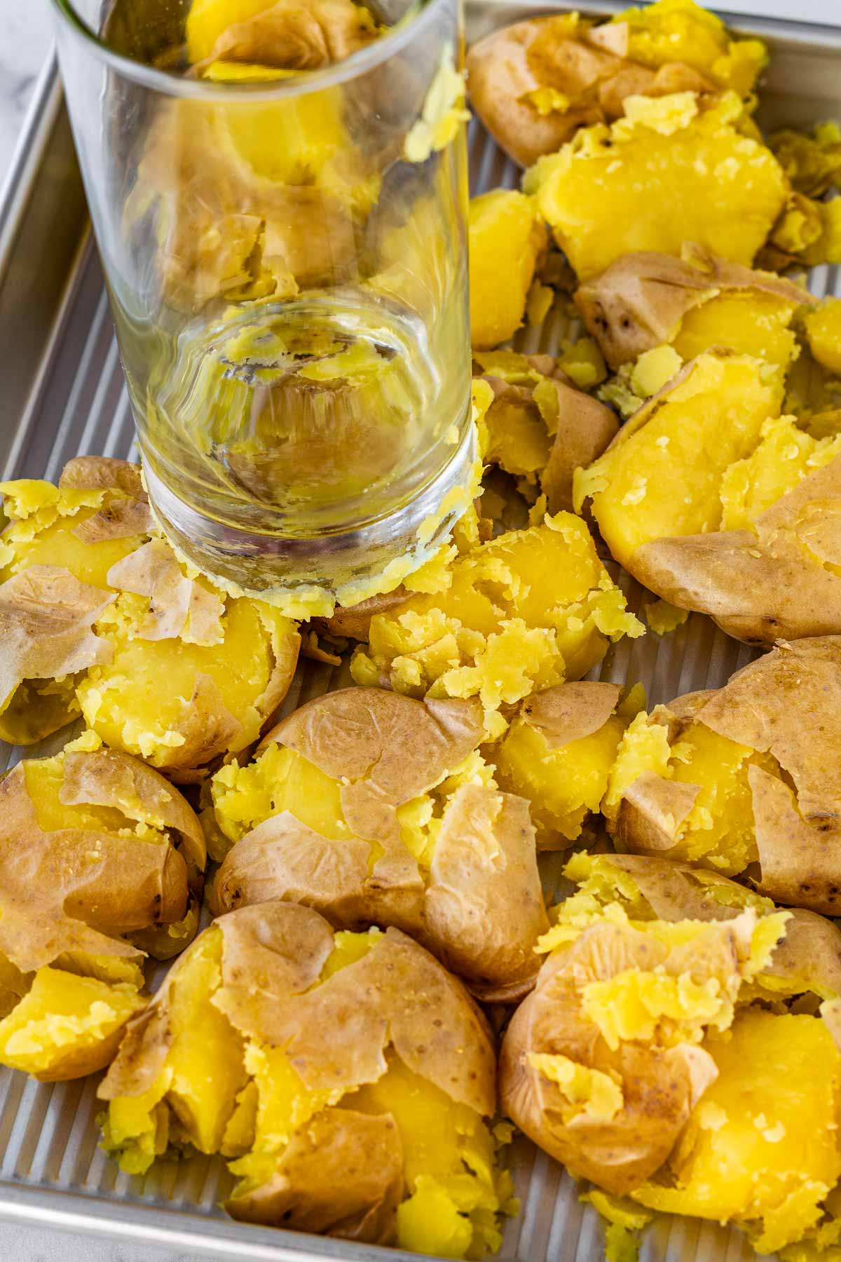 smashing potatoes with a glass