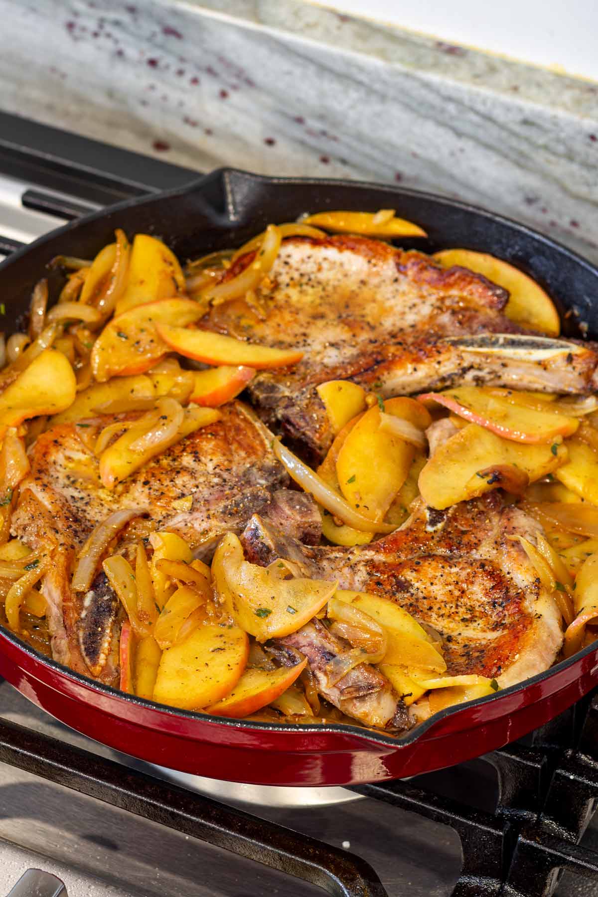 pork chops added to the skillet along with the apples and sauce