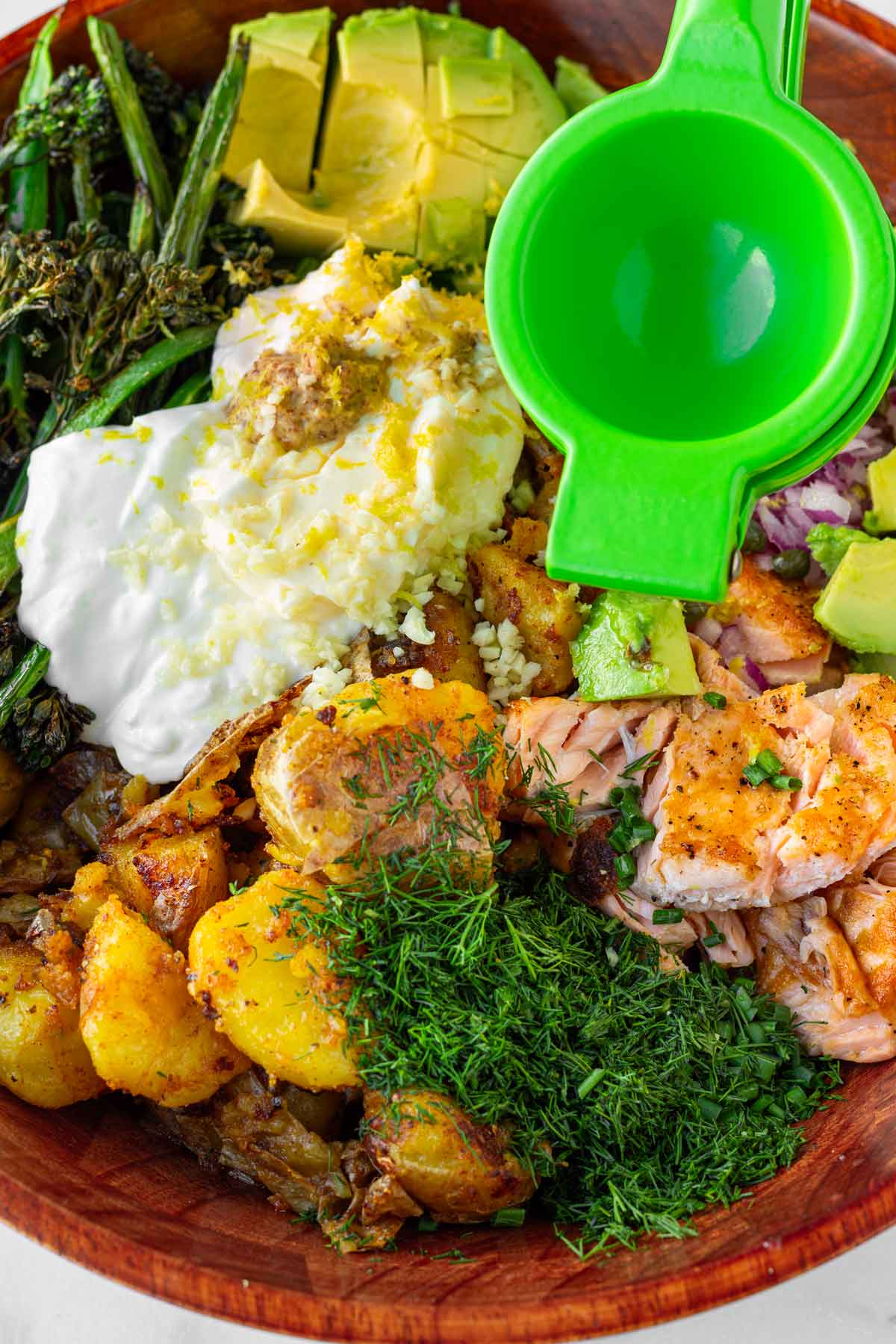 adding the dressing ingredients to the salad