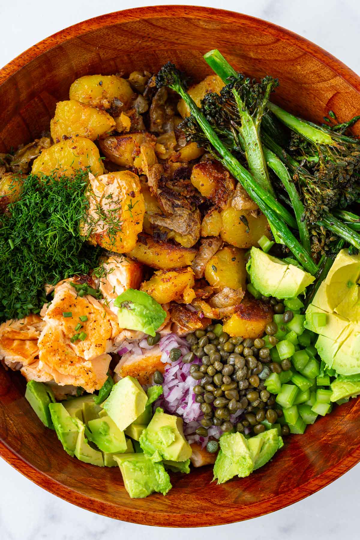 all salad ingredients combined in a wooden bowl