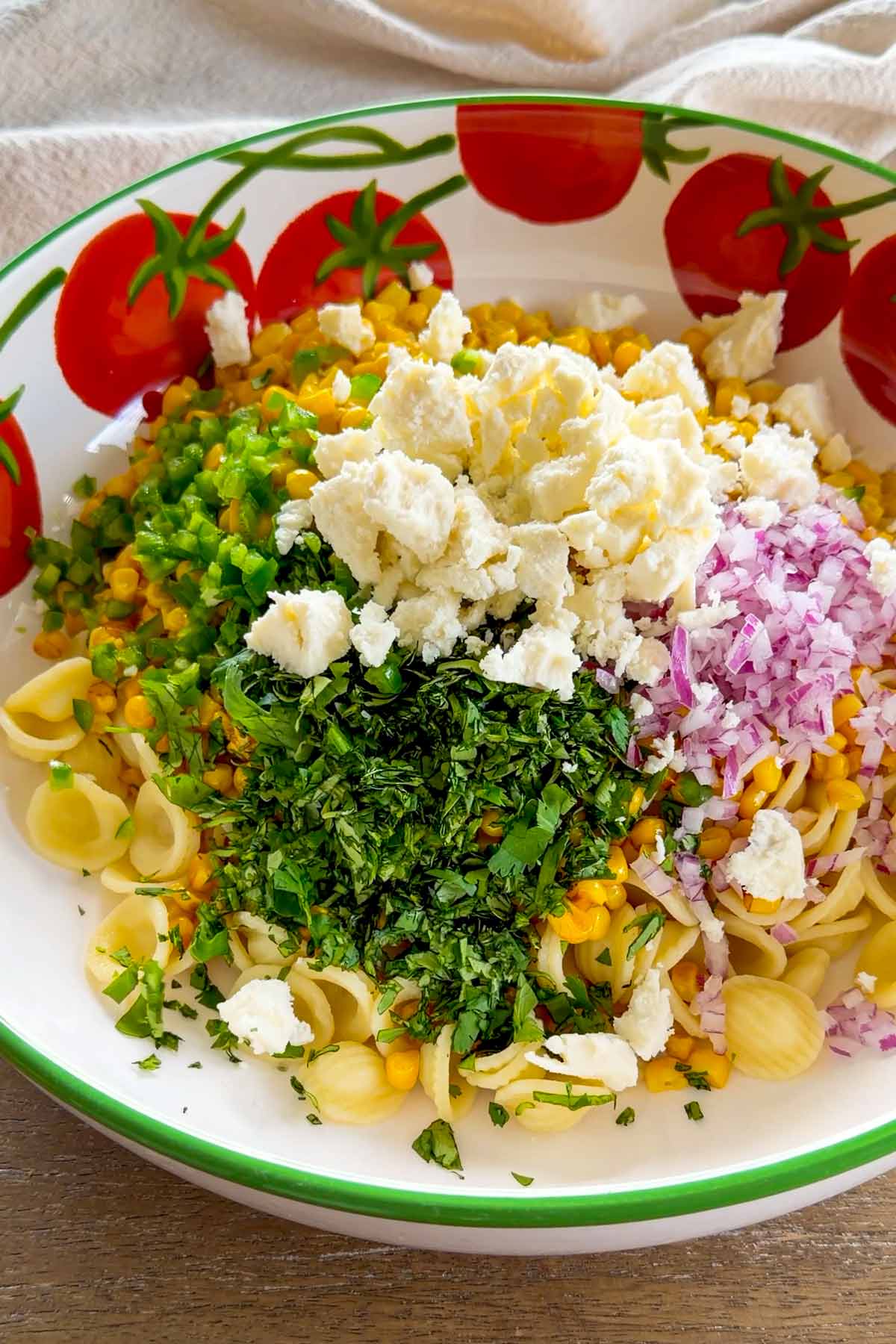 ingredients for mexican street corn salad combined in bowl