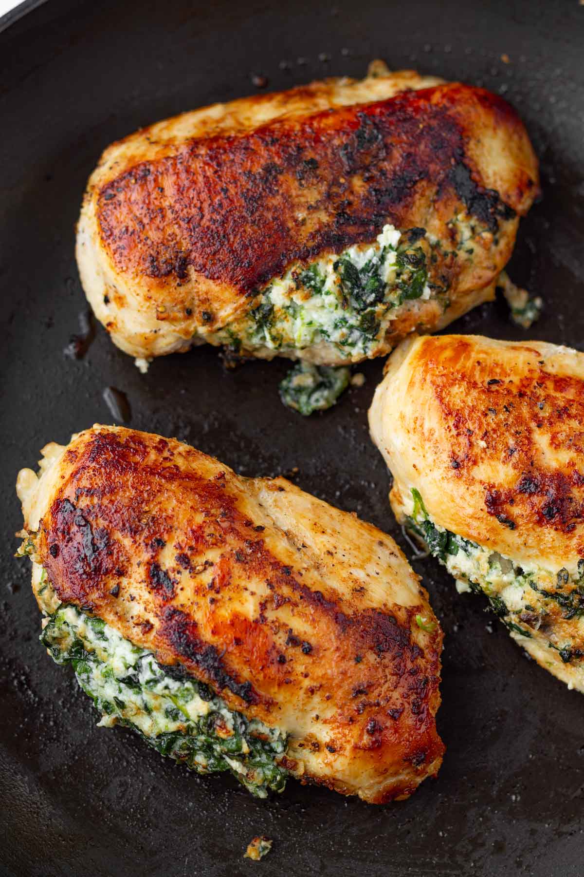 searing chicken on both sides on a skillet