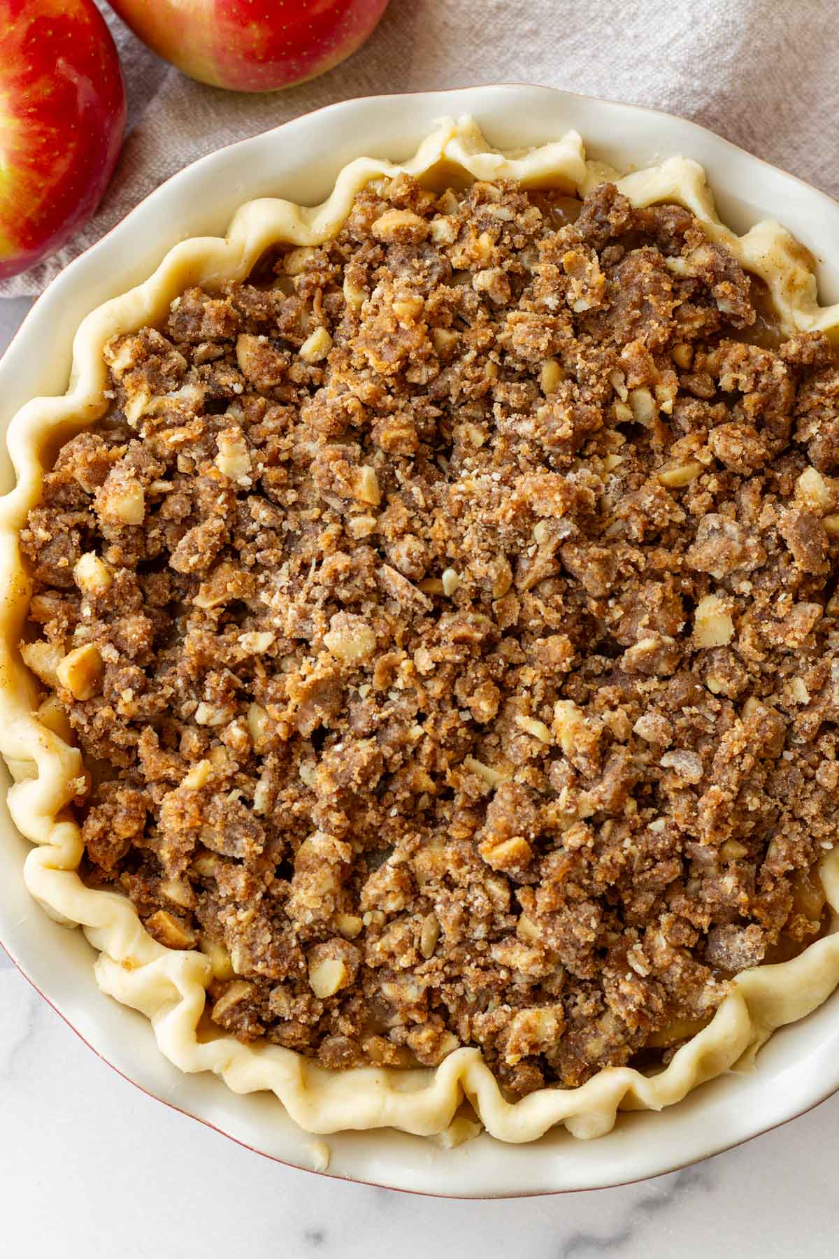 apple pie with crumb topping before baking