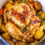 dutch oven whole chicken roasted on a bed of vegetables