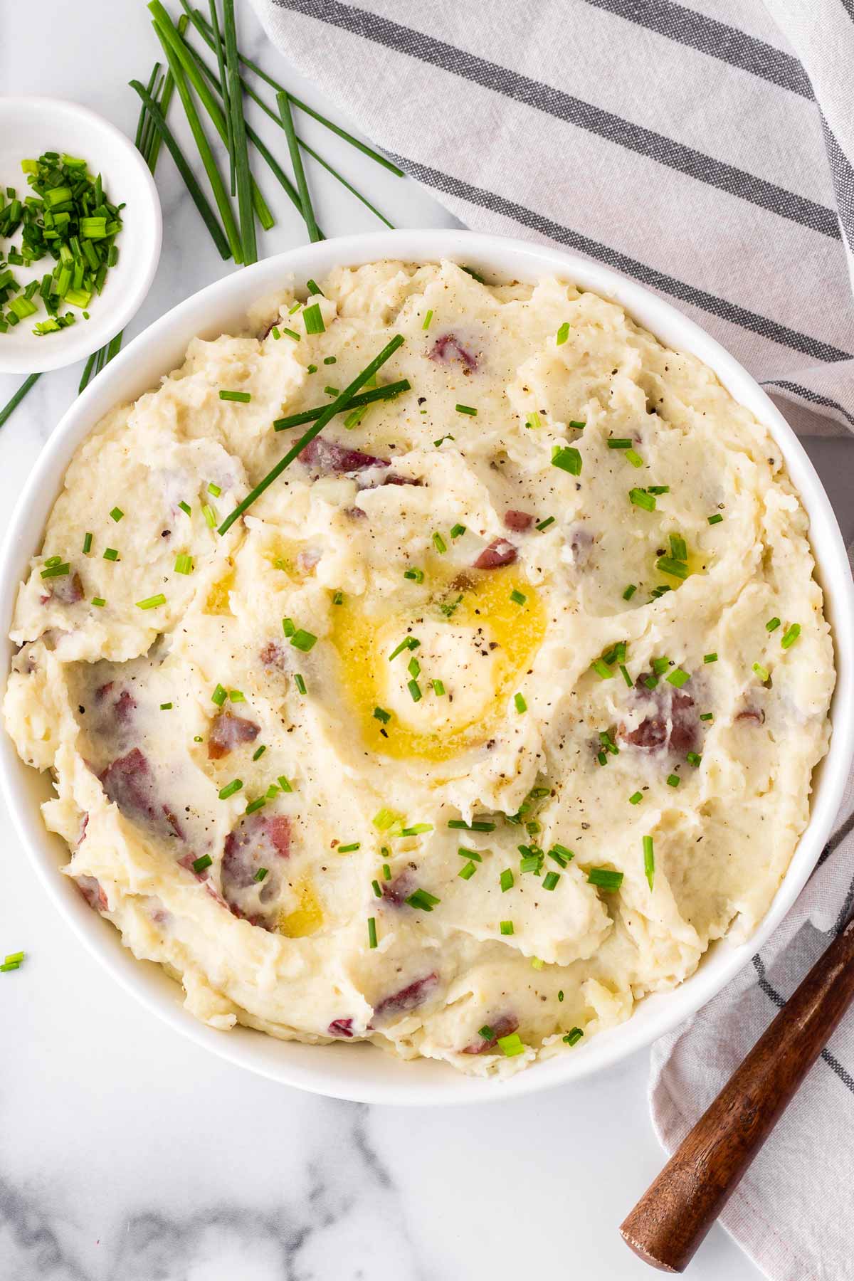 red skin mashed potatoes garnished in a bowl