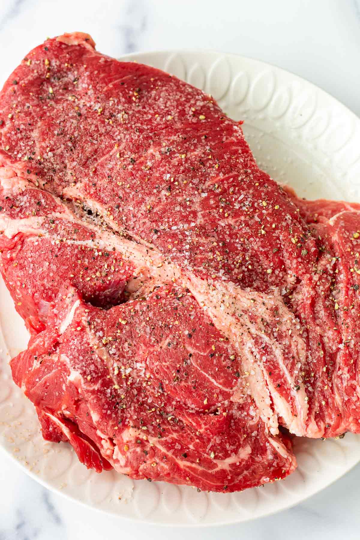 seasoning a piece of chuck roast
