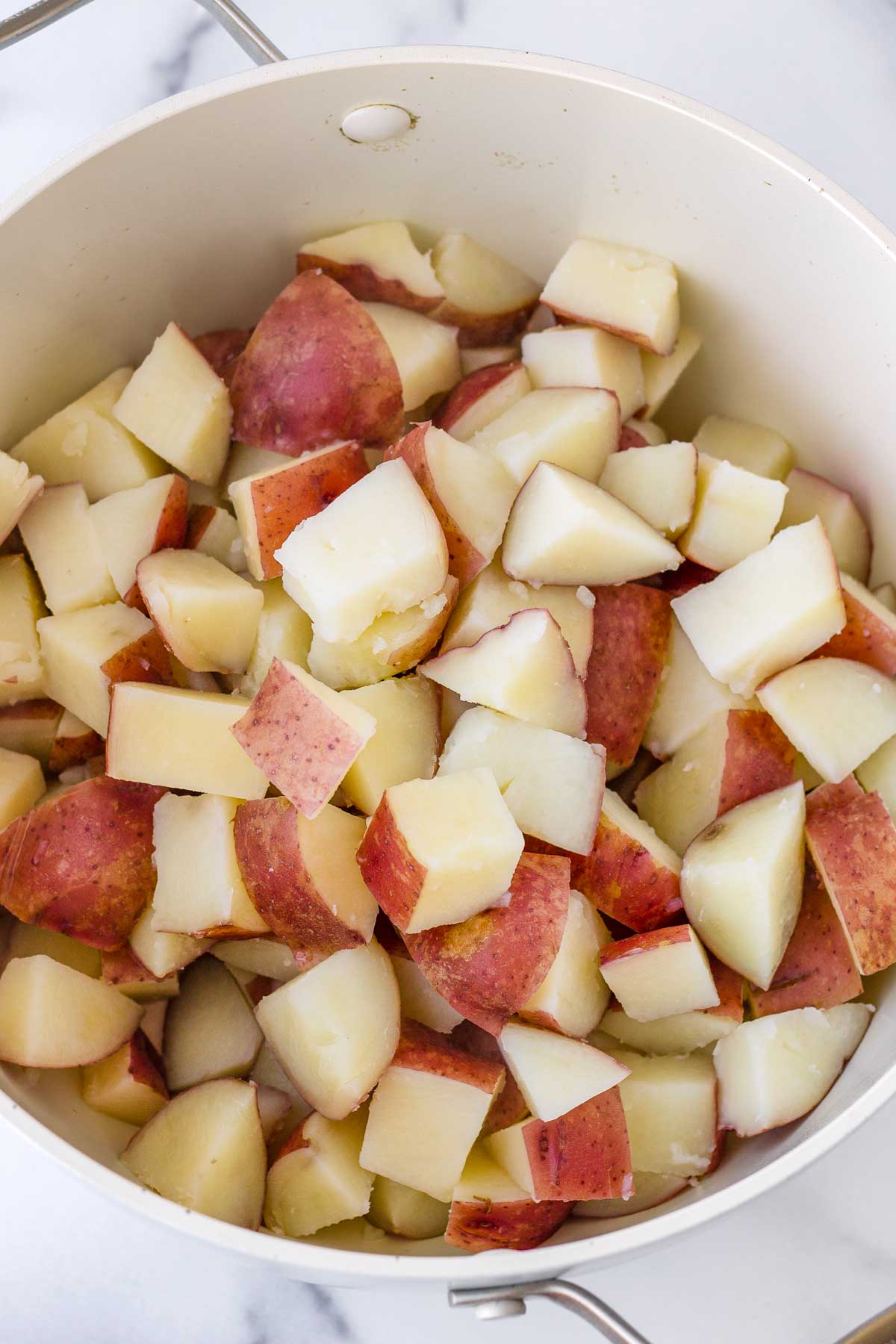 cooked cubed red potatoes in a pan