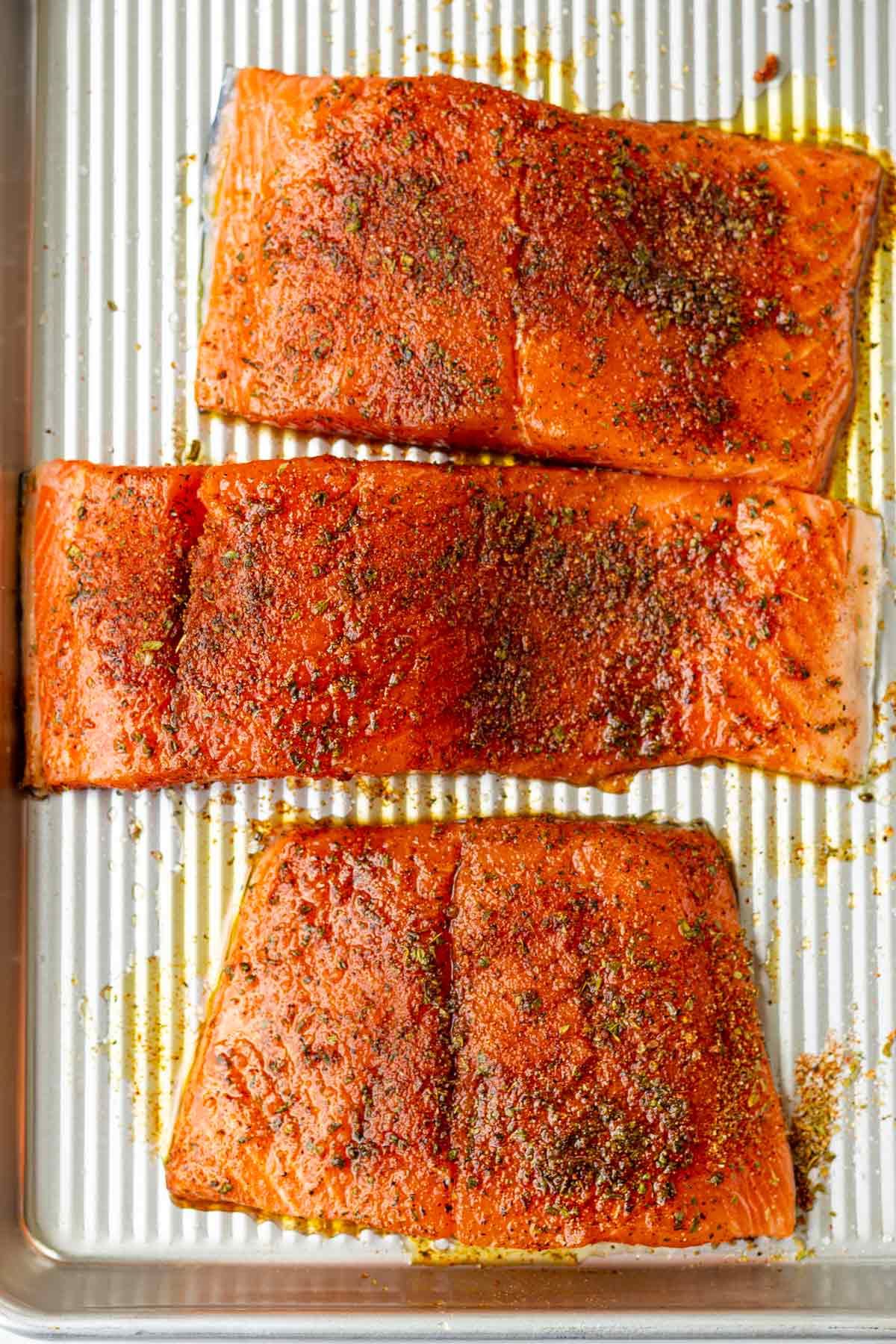 three salmon fillets seasoned with spices