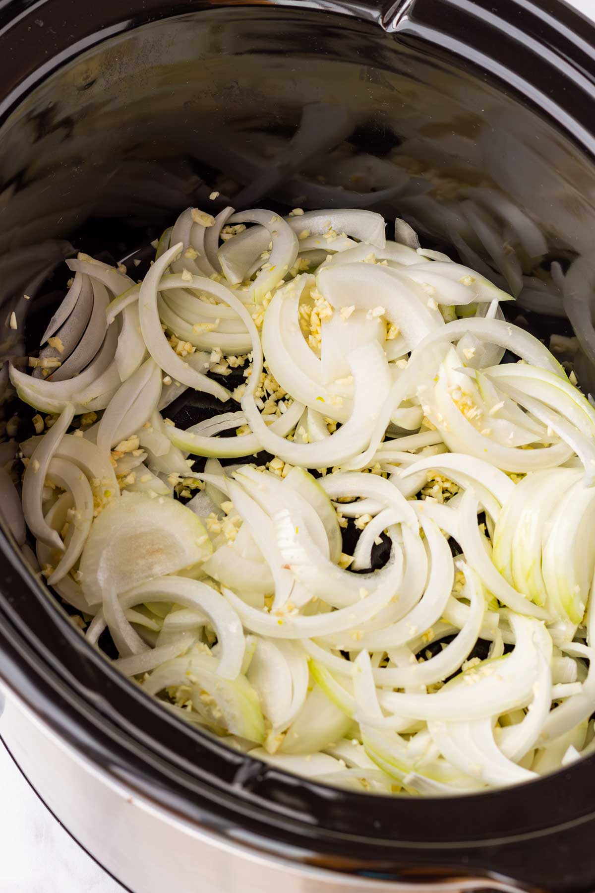 sliced onions and minced garlic addded in the crockpot