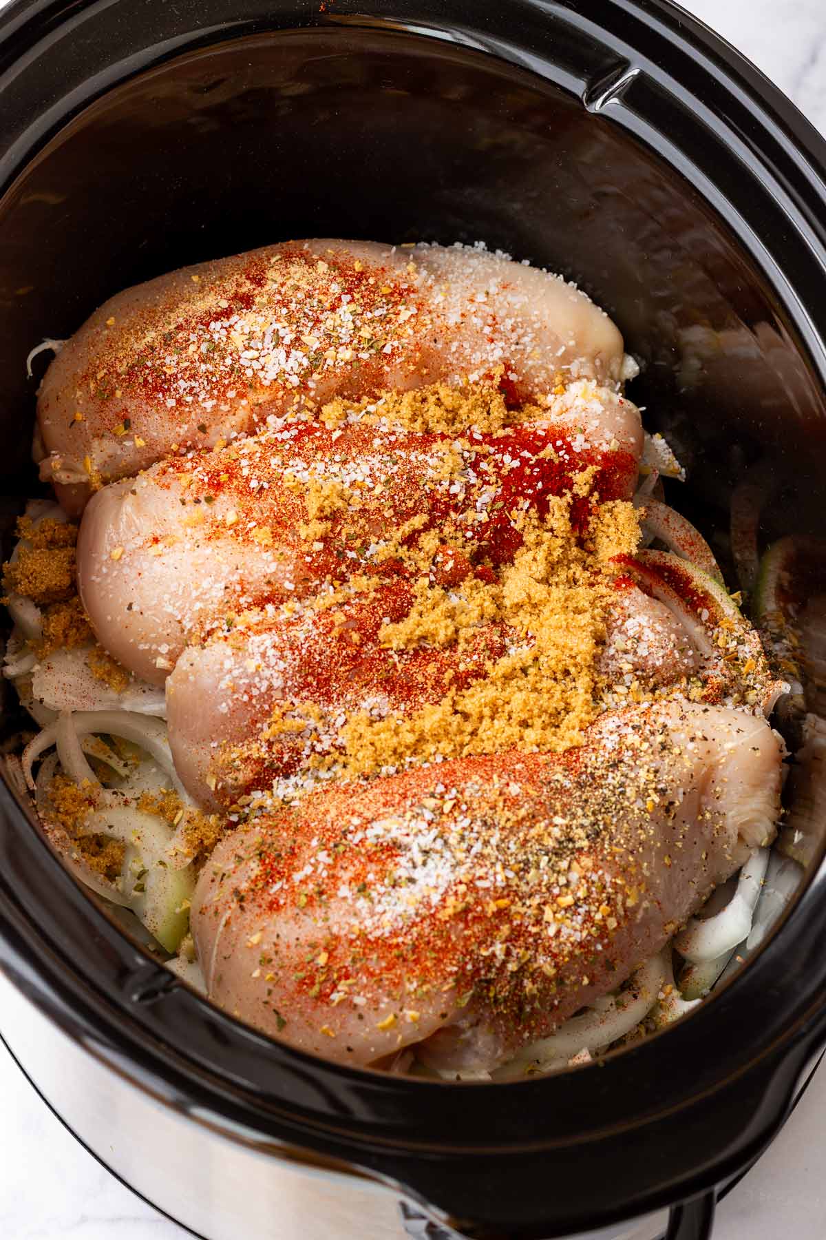 added chicken breatrs with seasoning and brown sugar on top