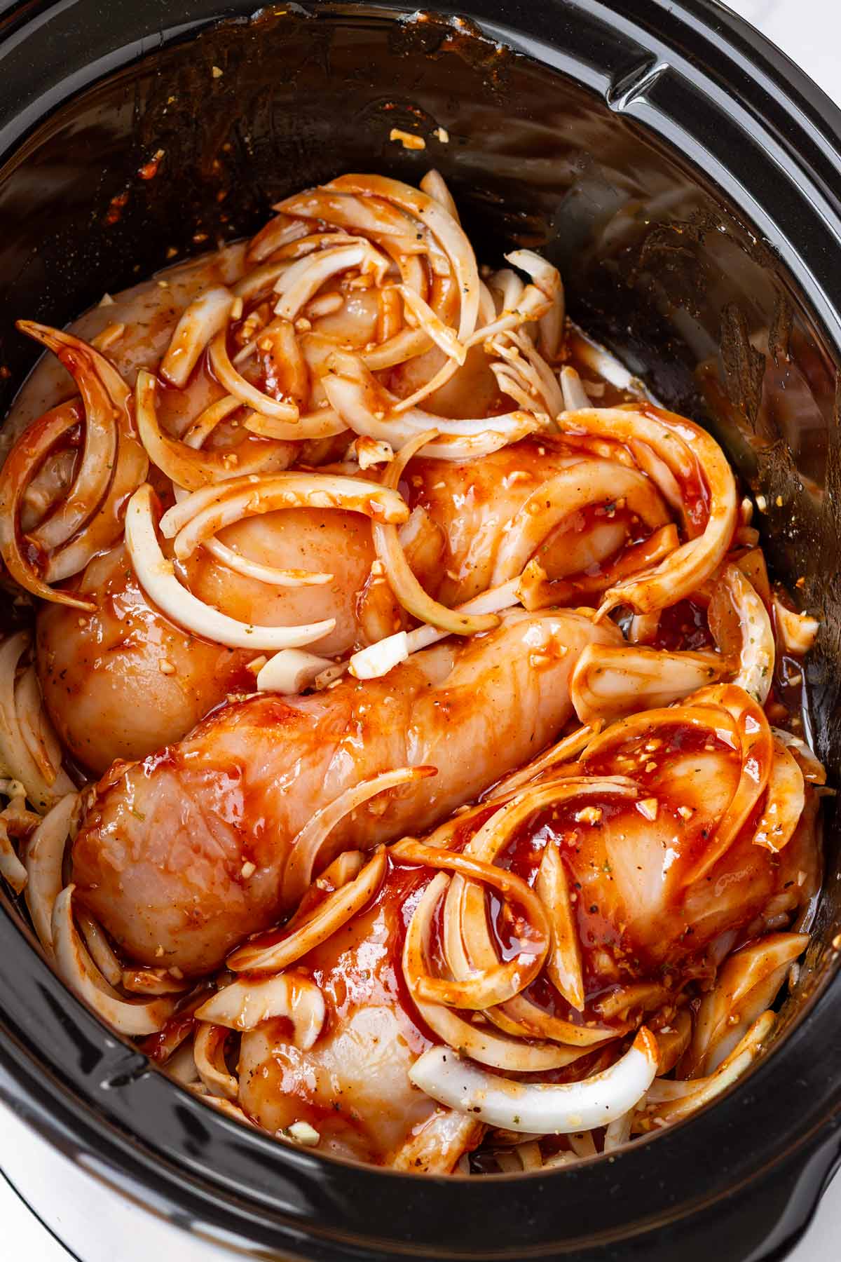added bbq sauce and liquids to the chicken in the crockpot before cooking