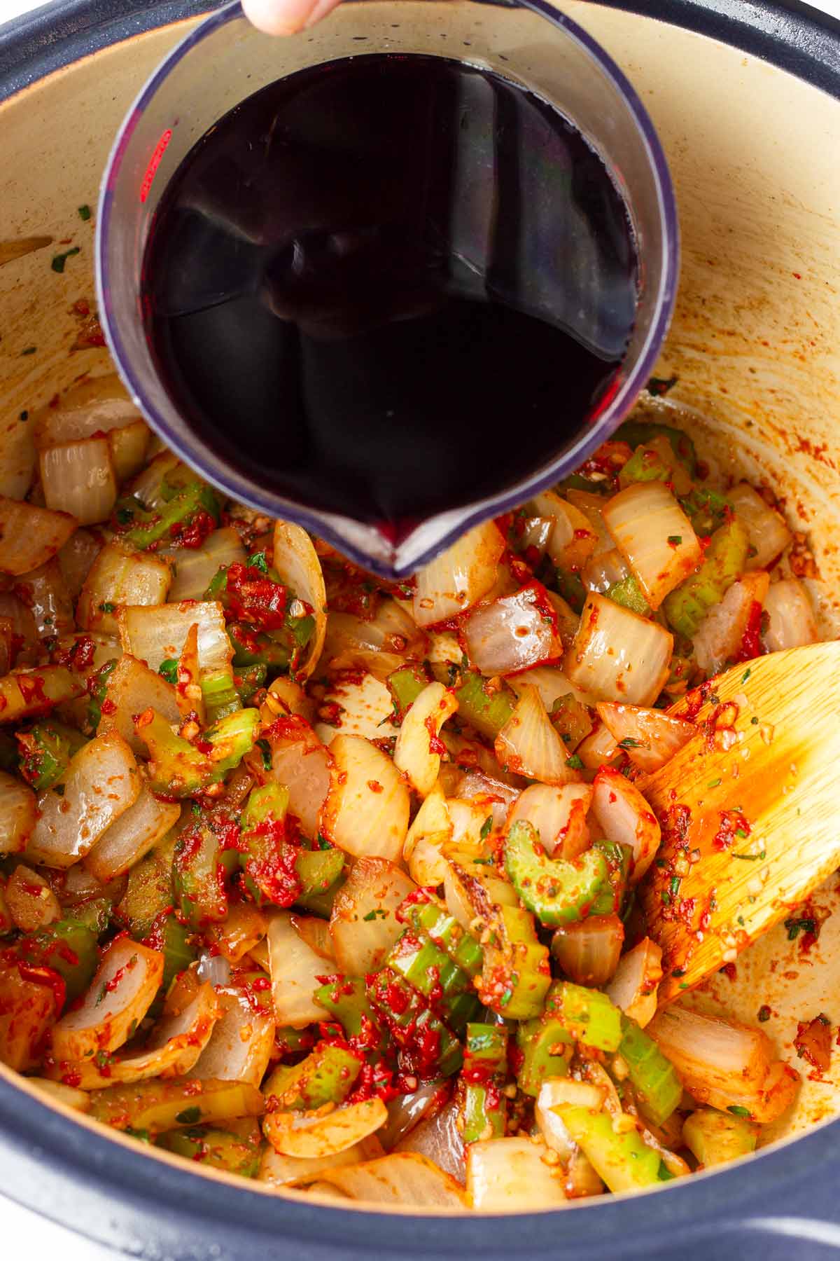 adding wine to the vegetables
