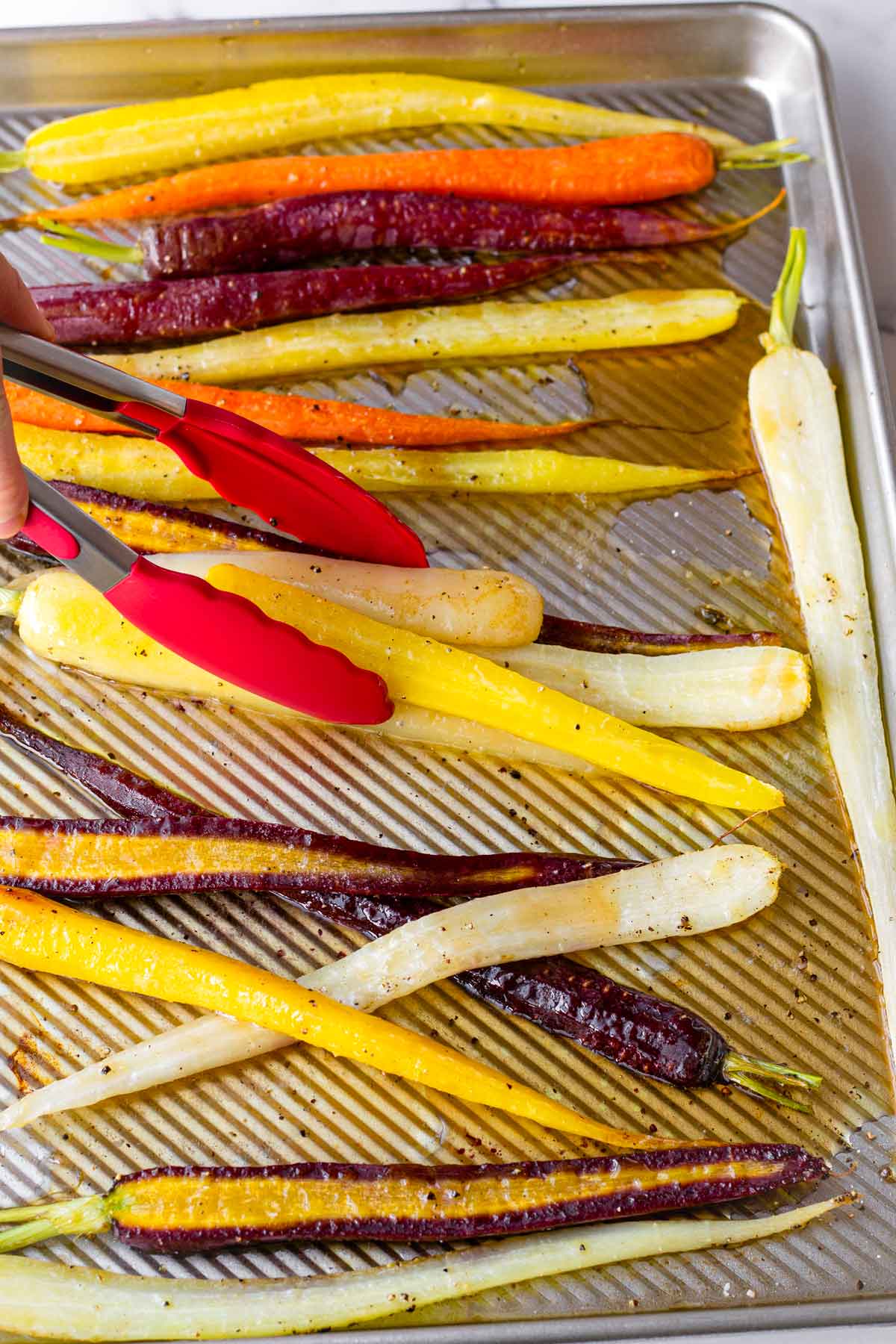 tossing carrots with glaze for roasting and broiling