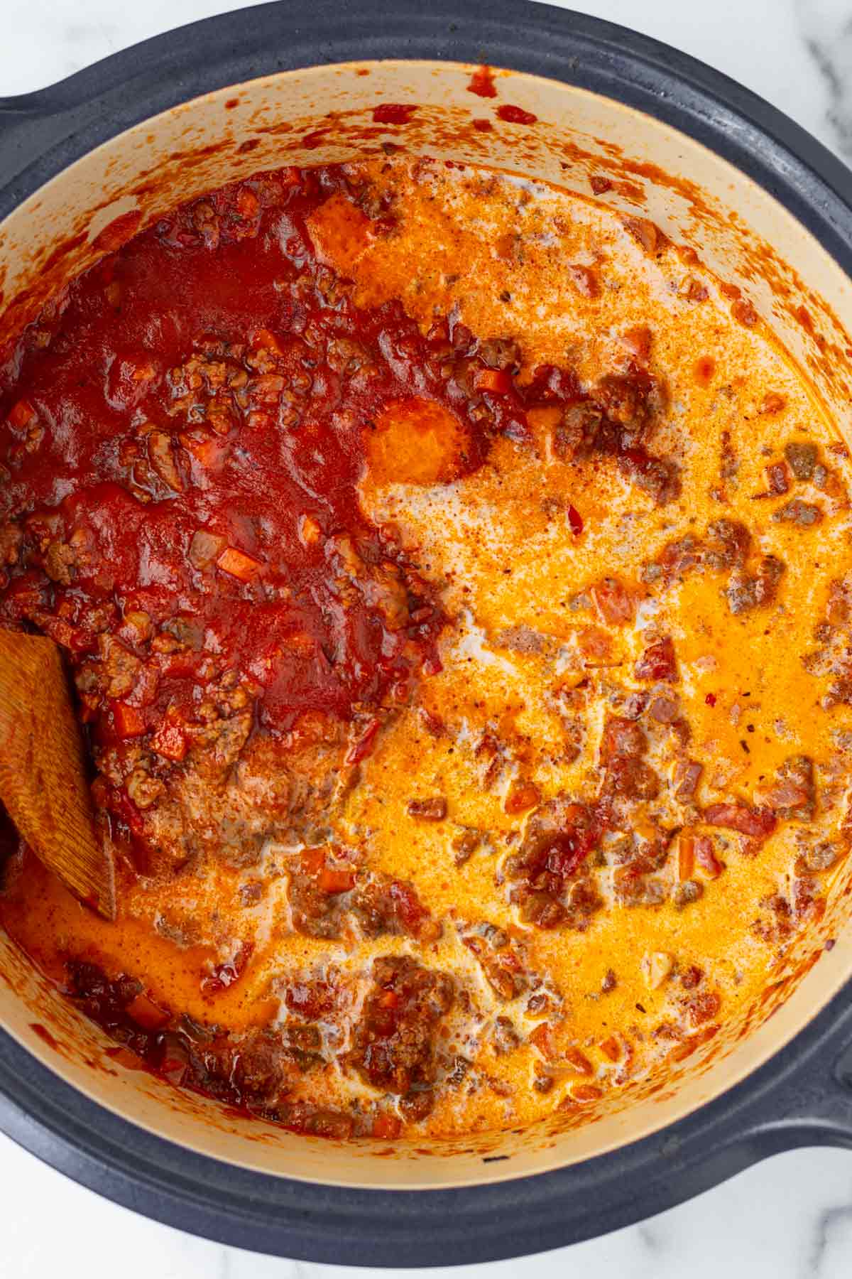 adding milk to the bolognese