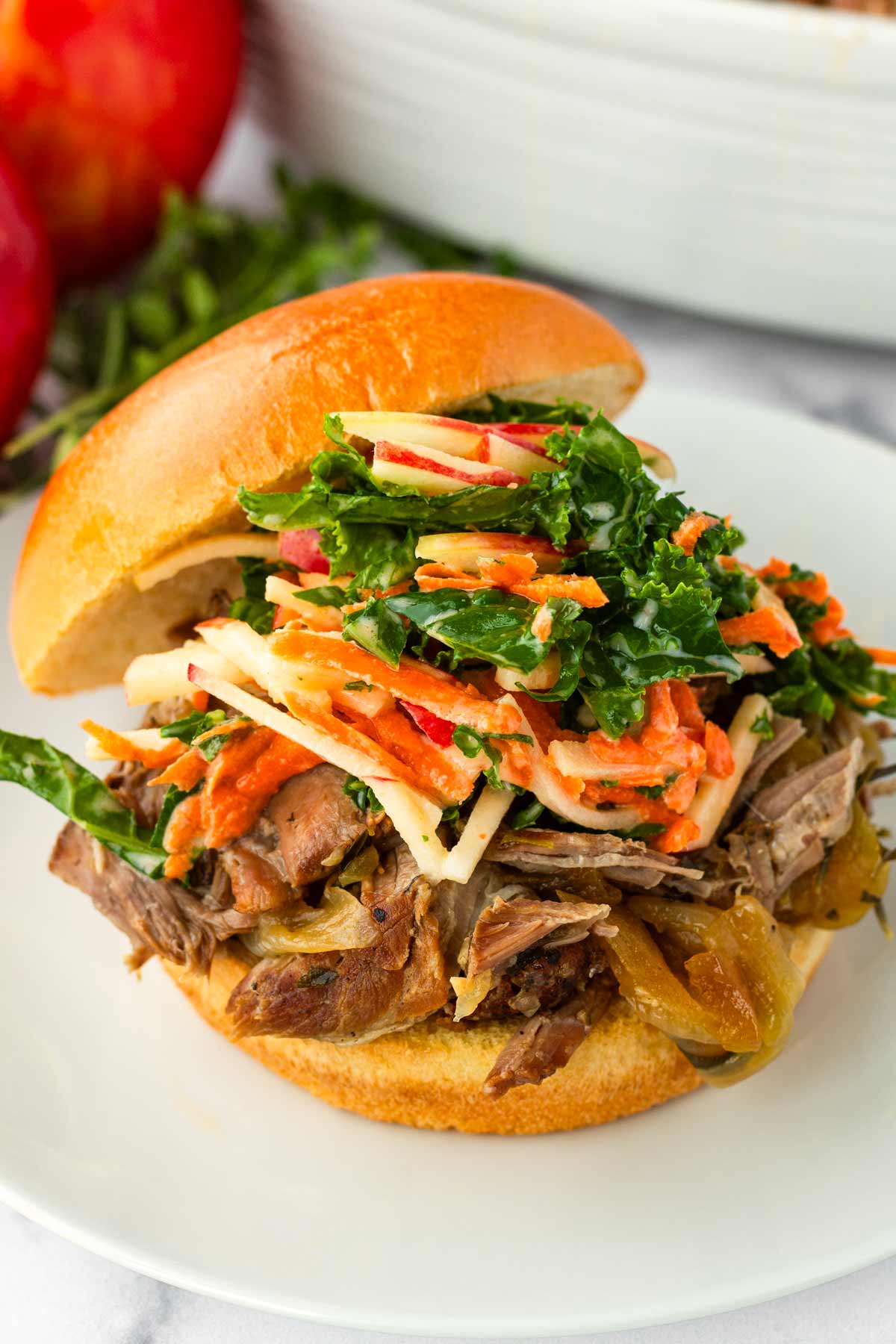 kale apple slaw on top of pulled pork sliders