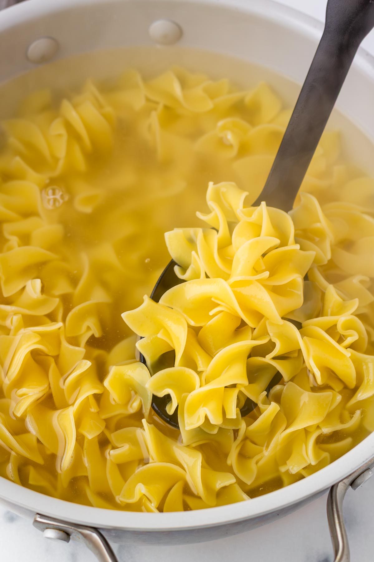 cooking egg noodles in a pot