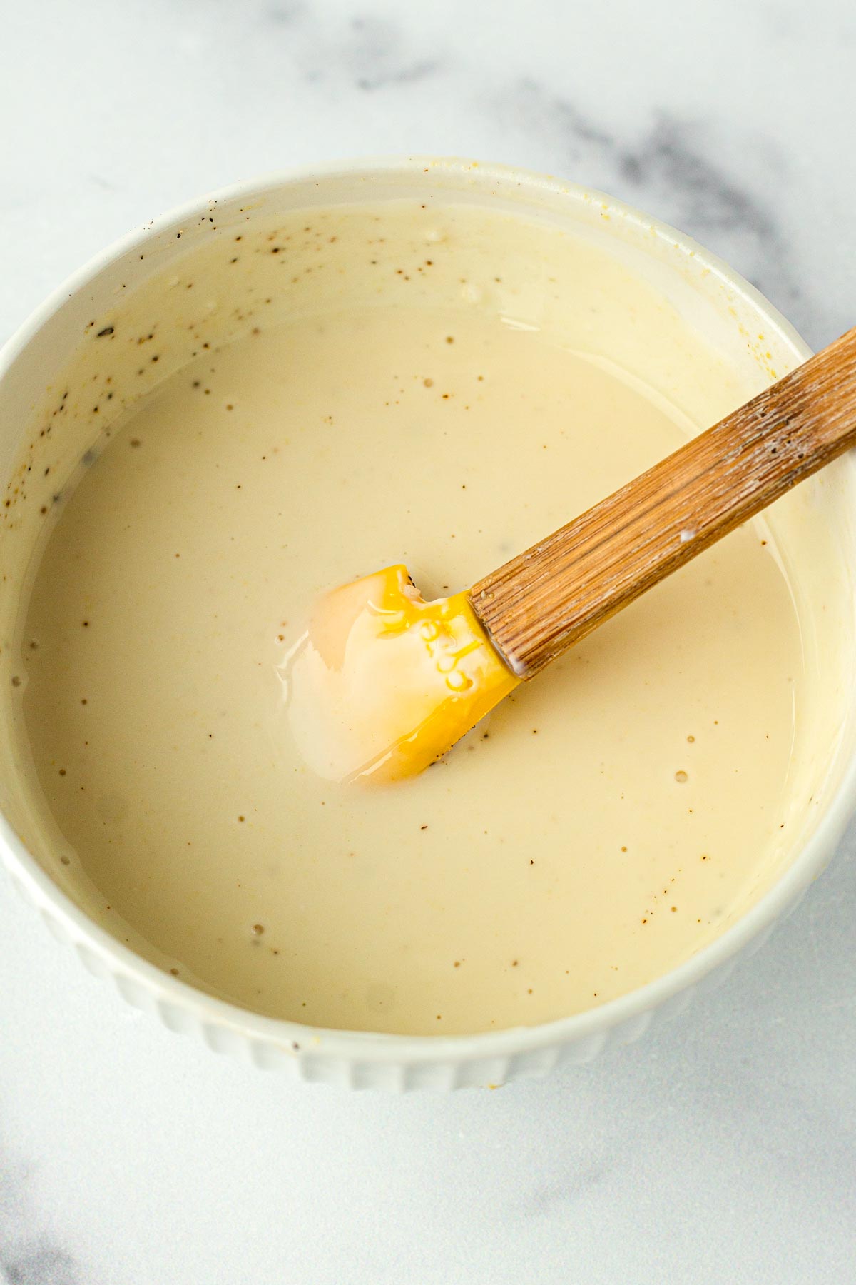 mixing the creamy maple dressing in bowl