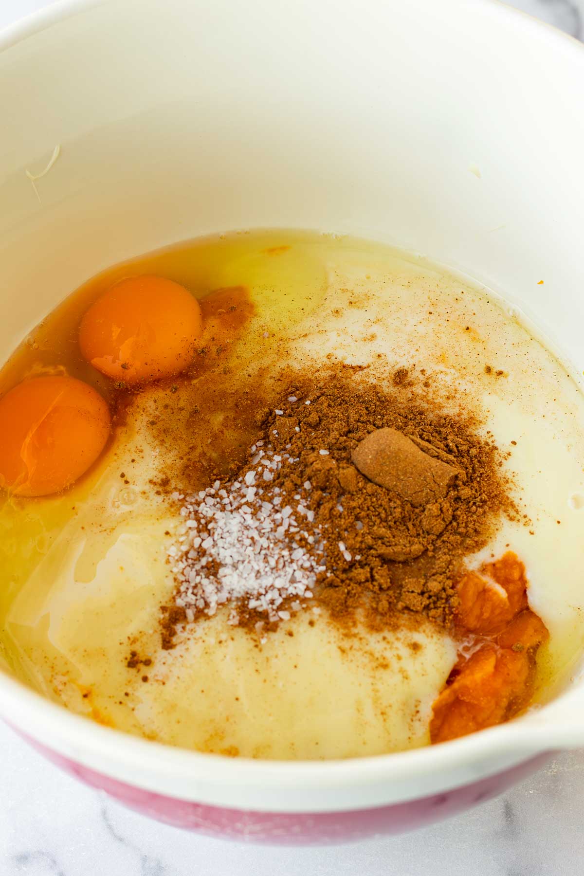 all the pumpkin pie filling ingredients combined in a mixing bowl