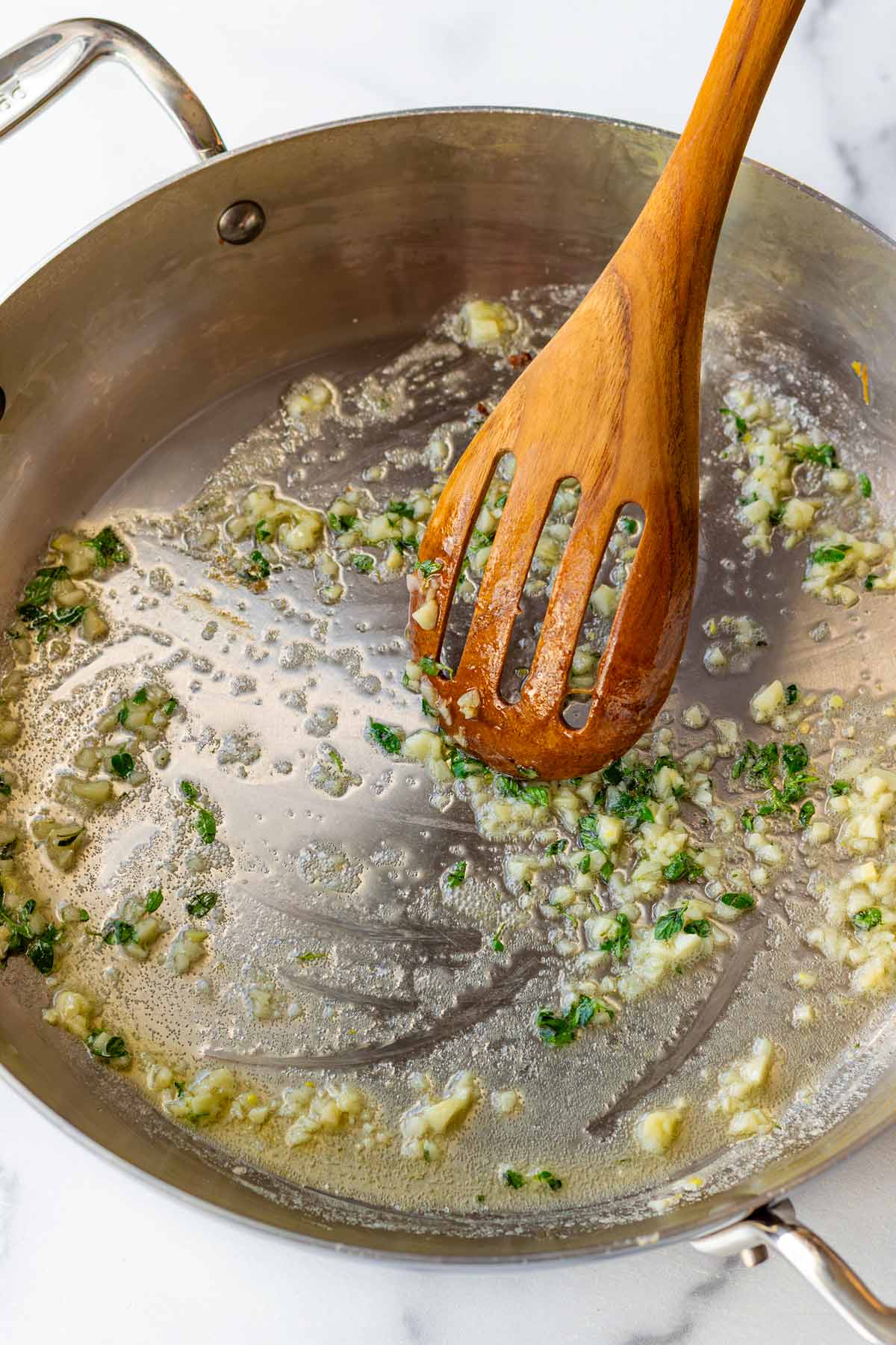 sauteeing garlic and aromatics in pan