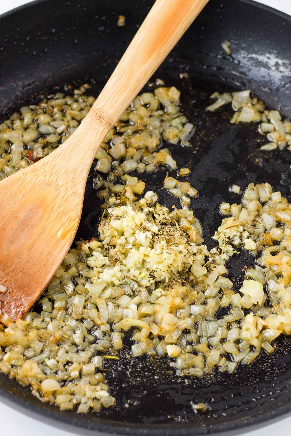 sauteing onions, garlic, and aromatics in pan