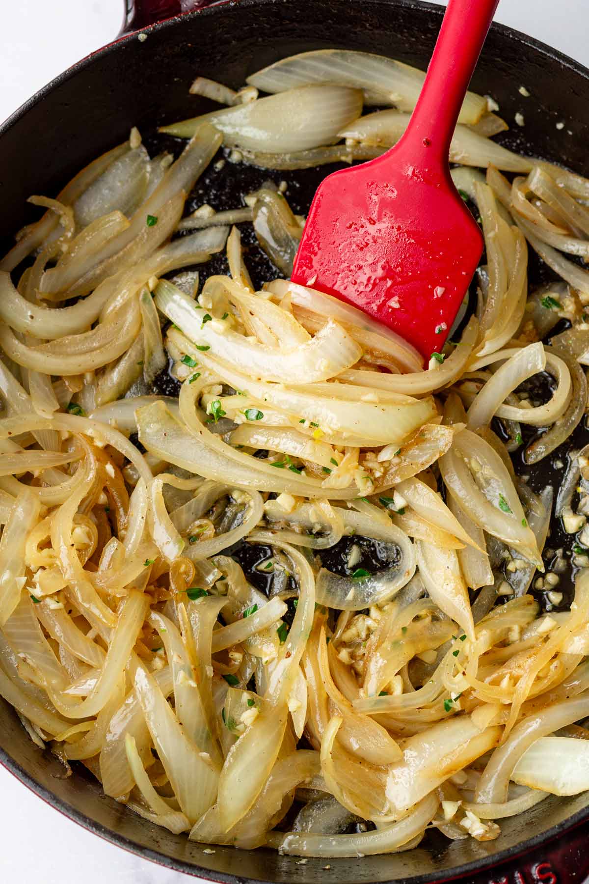 sauteing onions and aromatics in a pan