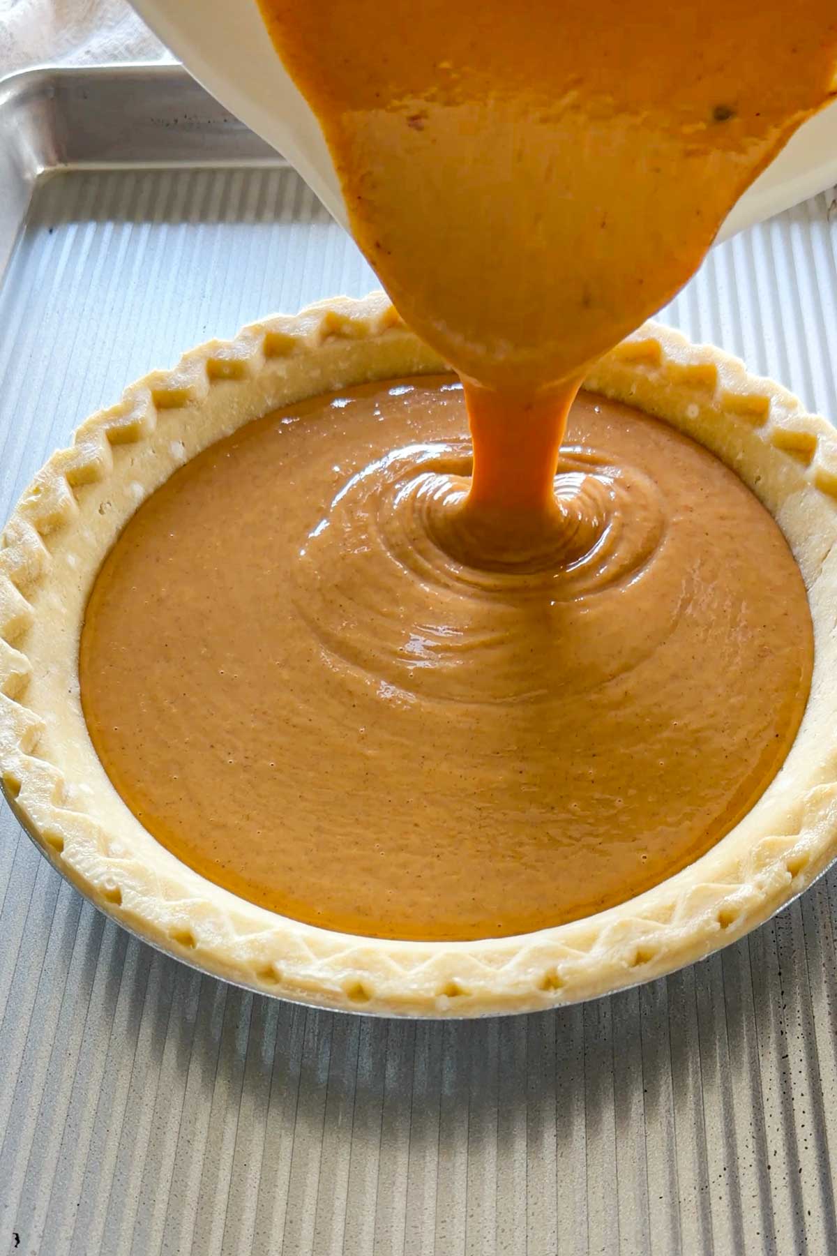 pouring the filling into the pie crust shell