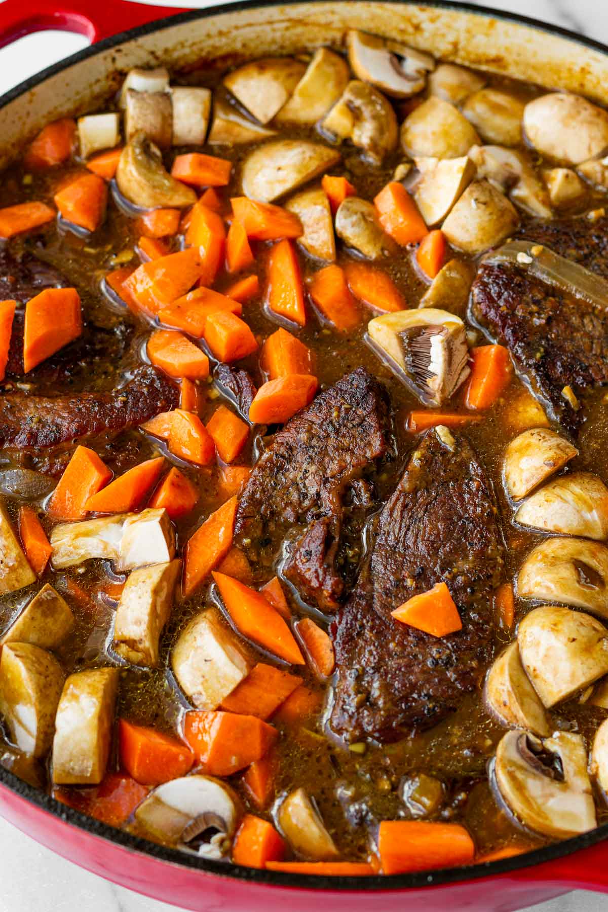 adding carrots and mushrooms