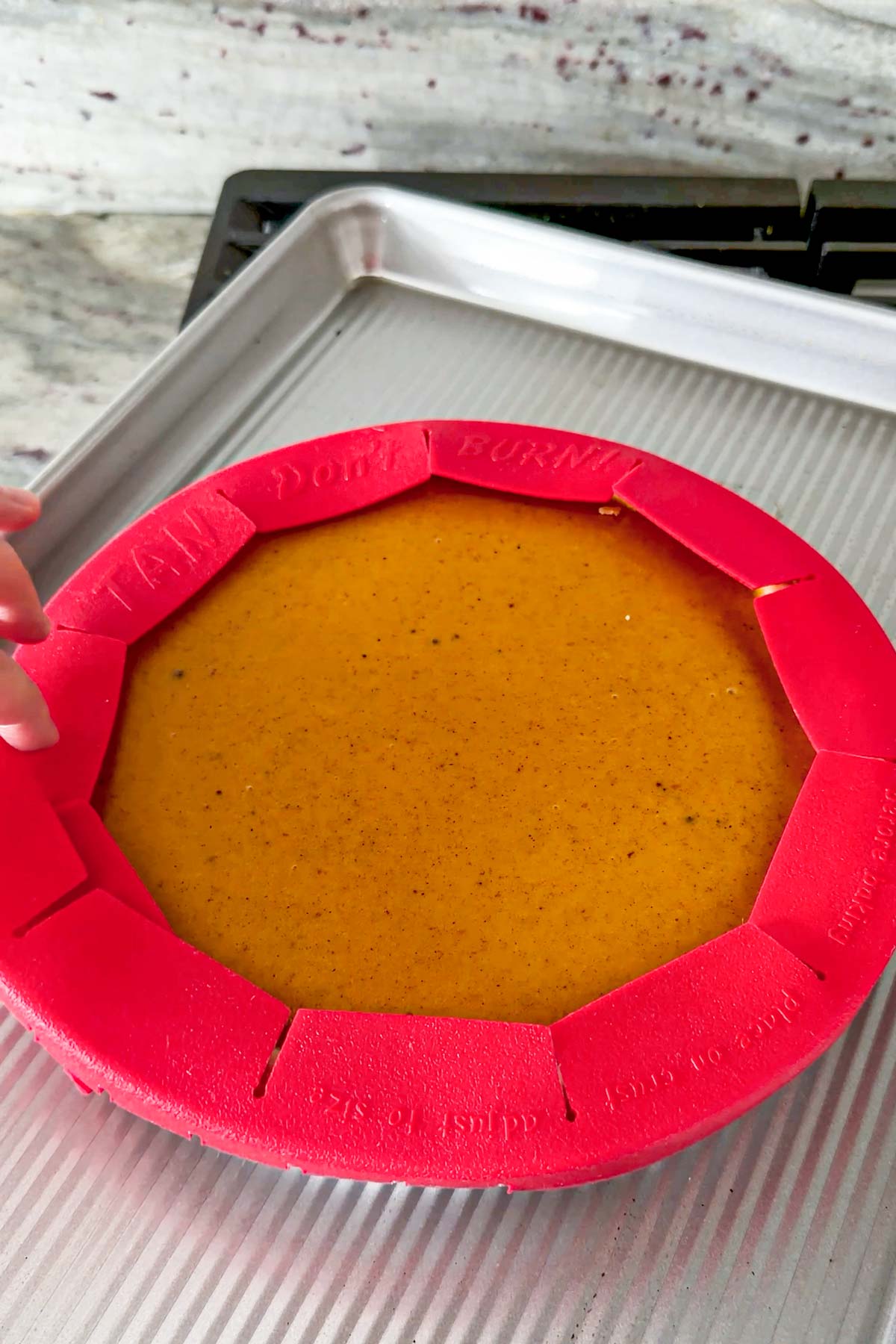 putting pie crust shield around the edges