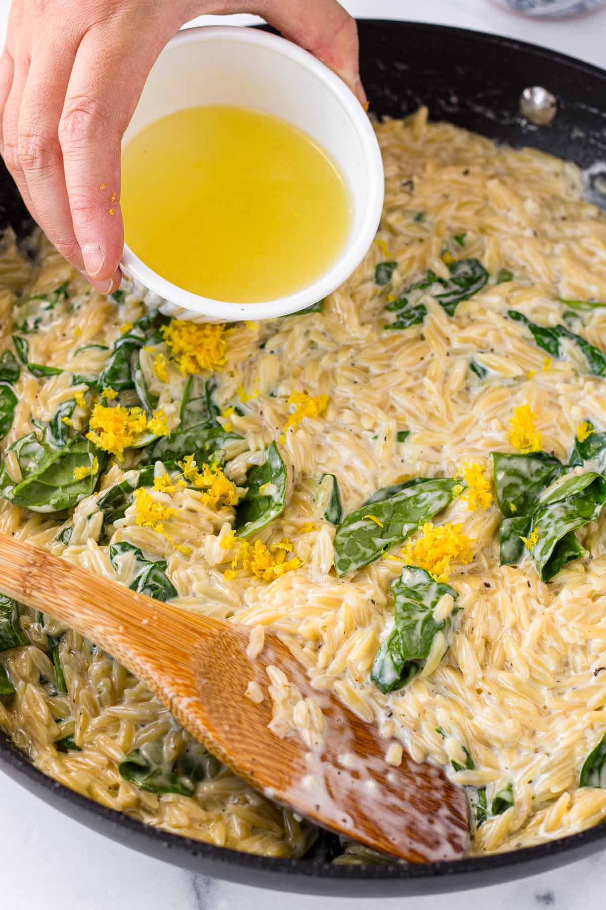 adding spinach, lemon juice and zest