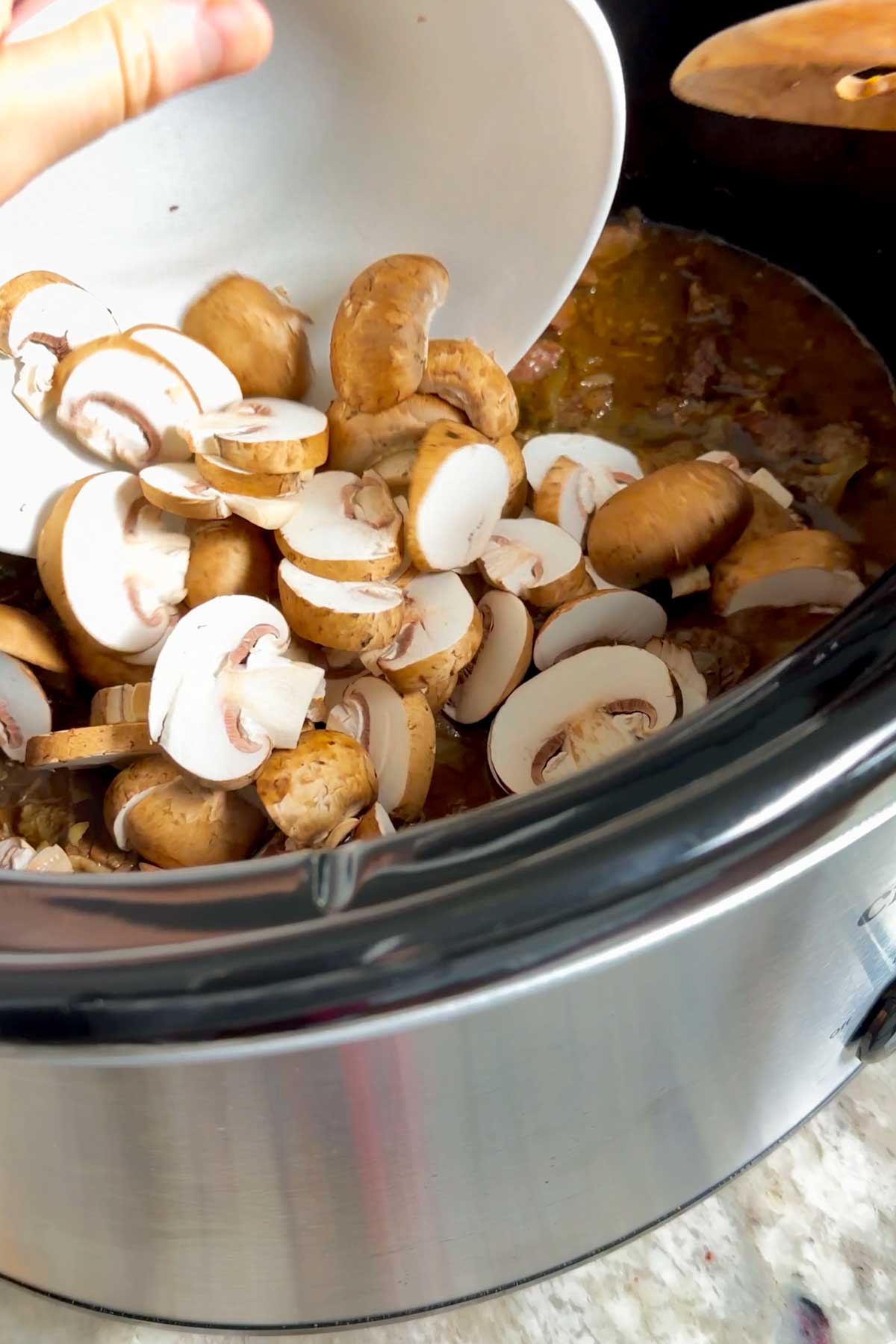 adding mushrooms to the stroganoff